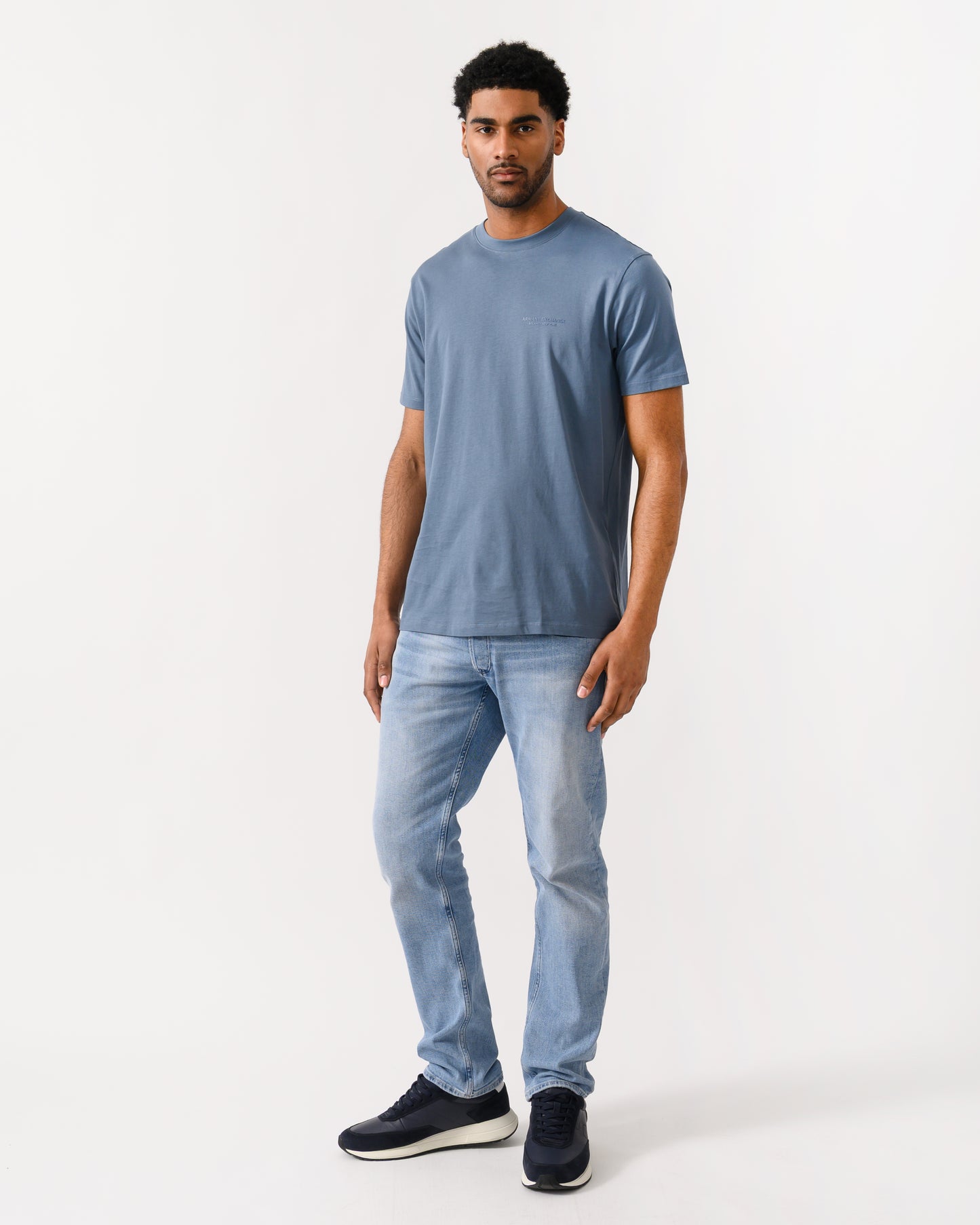 full length shot of a model wearing a Armani Exchange Mens T-Shirt with Small Milano-New York Logo in China Blue