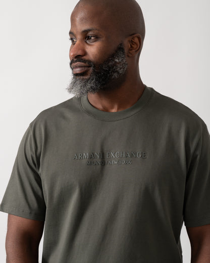 Close up shot of a Model wearing an Armani Exchange Mens T-Shirt with Tonal Milano/New York Logo in Chimera