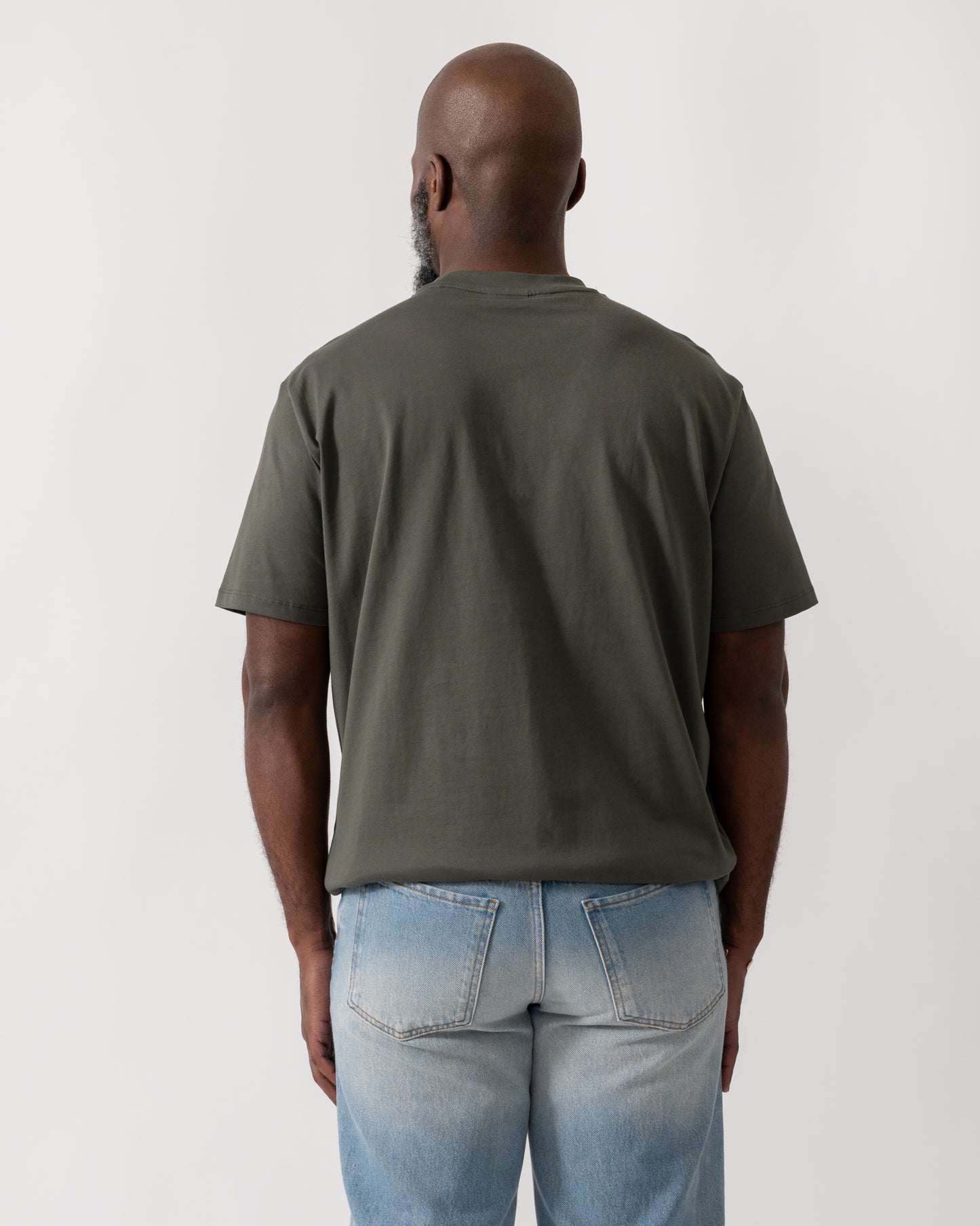 back shot of a Model wearing an Armani Exchange Mens T-Shirt with Tonal Milano/New York Logo in Chimera