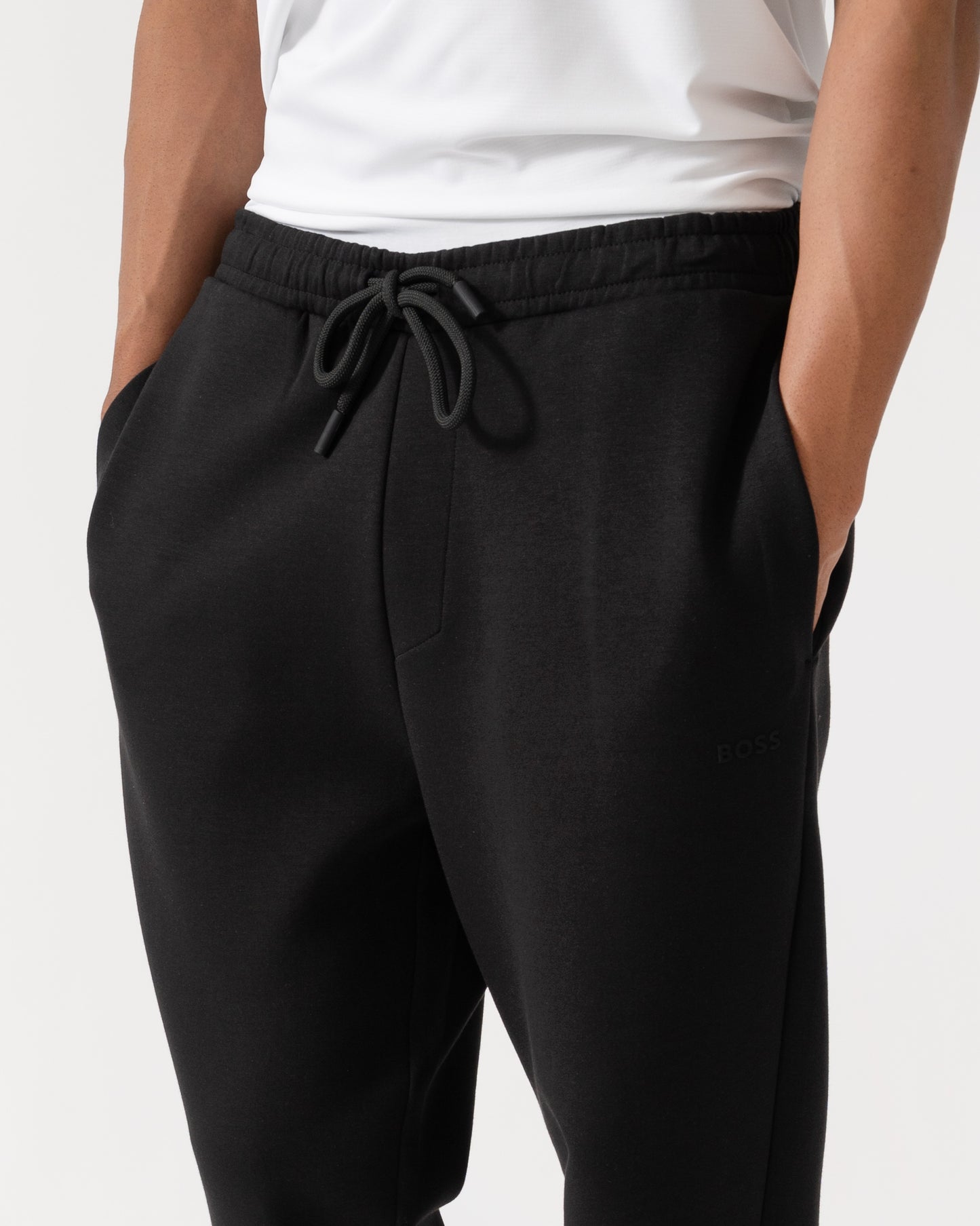 Close up of BOSS Green Hadiko Mens Stretch-cotton track pants with puff-print logo - Black 001