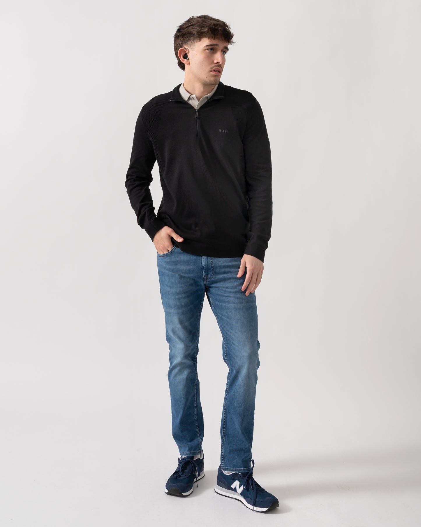full length shot of a model wearing a BOSS Green Momentum-Lite Mens quarter Zip Funnel Neck Jumper in Black 001