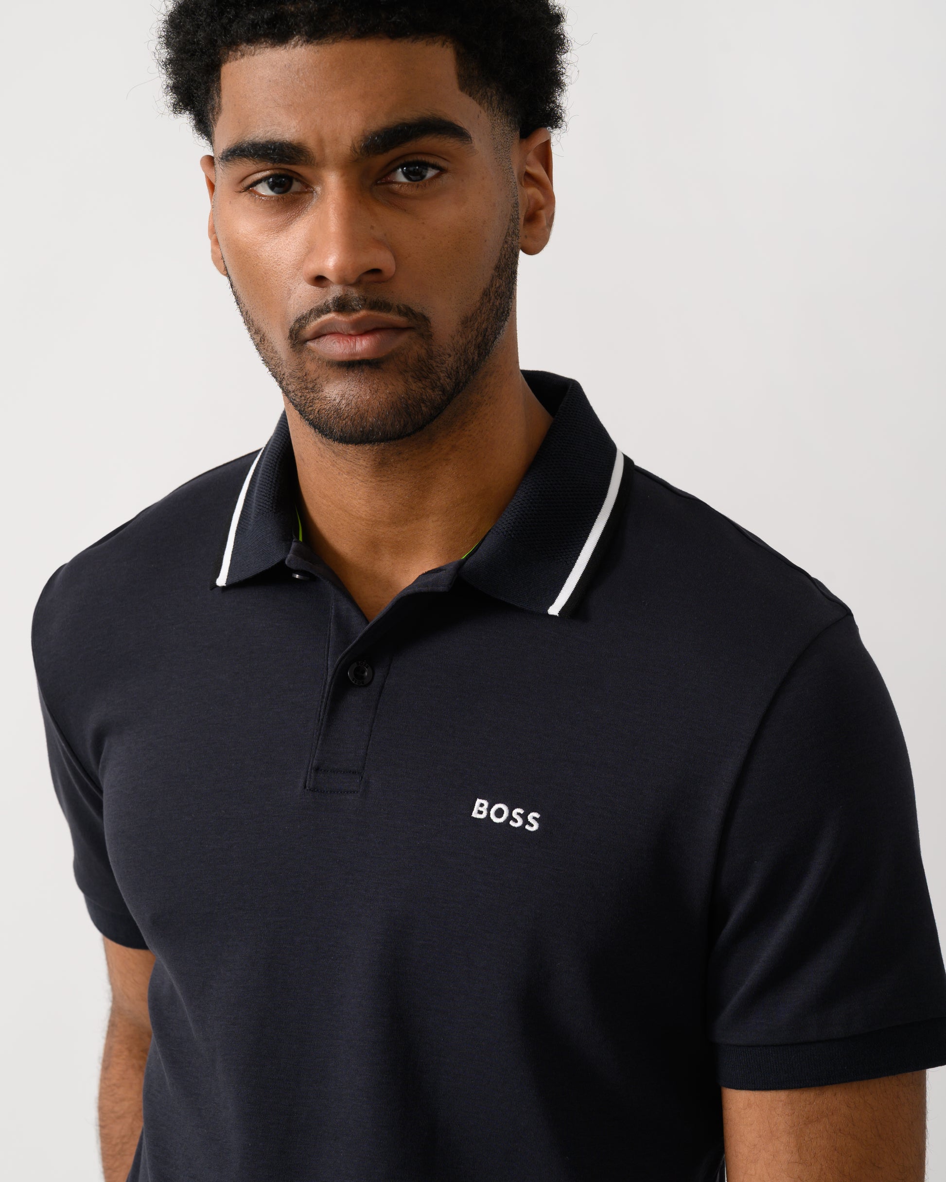 close up shot of a Model wearing a BOSS Green Paddy Mens Slim-Fit Polo Shirt in Interlock Cotton in Dark Blue 402