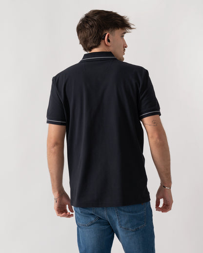 back shot of a model wearing a BOSS Green PL_Member Mens Short Sleeve Polo Shirt in Dark Blue 402
