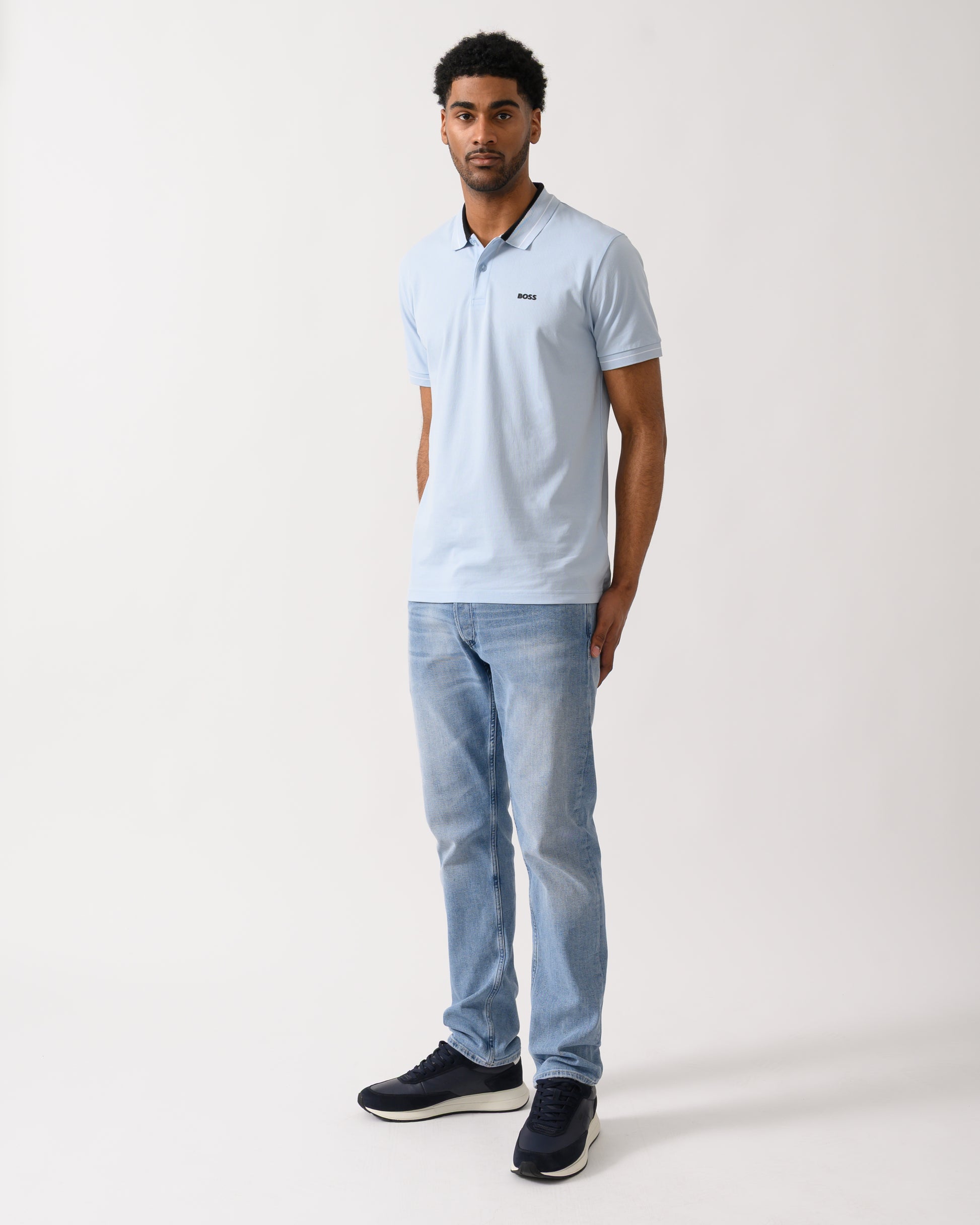 full length shot of a Model wearing a BOSS Green PL_Member Mens Short Sleeve Polo Shirt in Open Blue 460