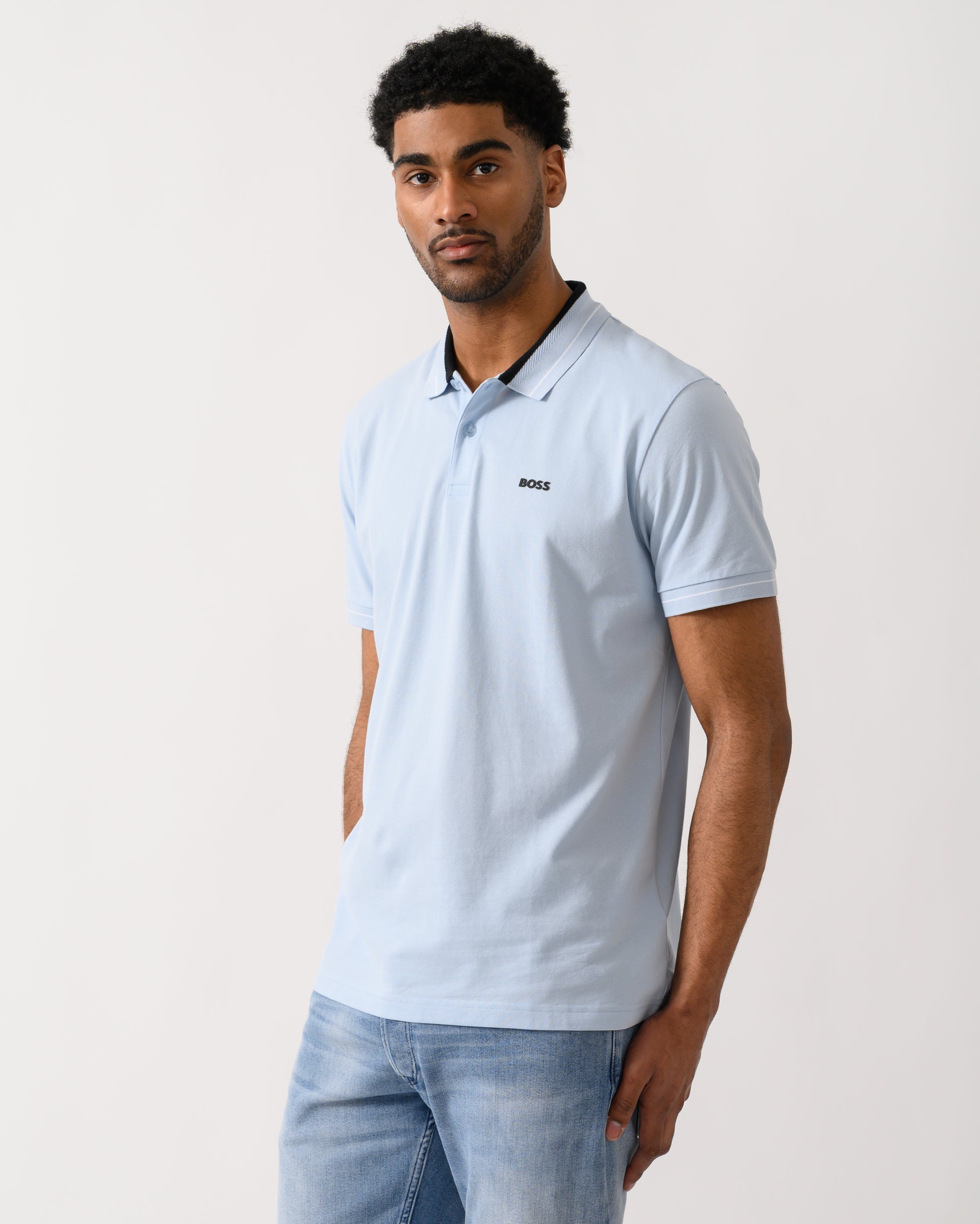 Model wearing a BOSS Green PL_Member Mens Short Sleeve Polo Shirt in Open Blue 460