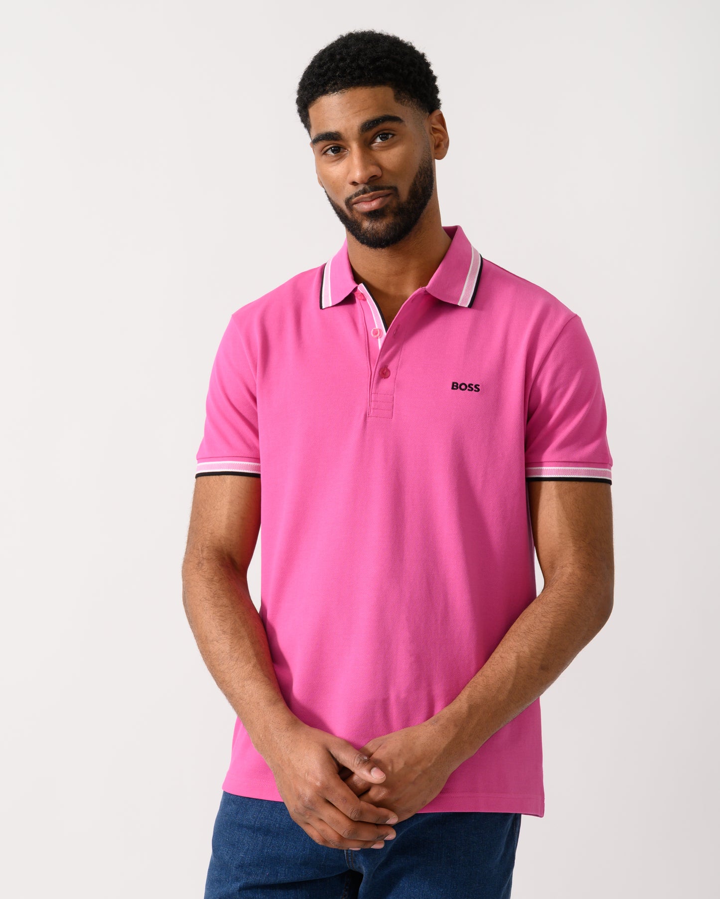 model wearing a BOSS Green Paddy Mens Cotton-Piqué Polo Shirt with Contrast Logo in Bright Pink