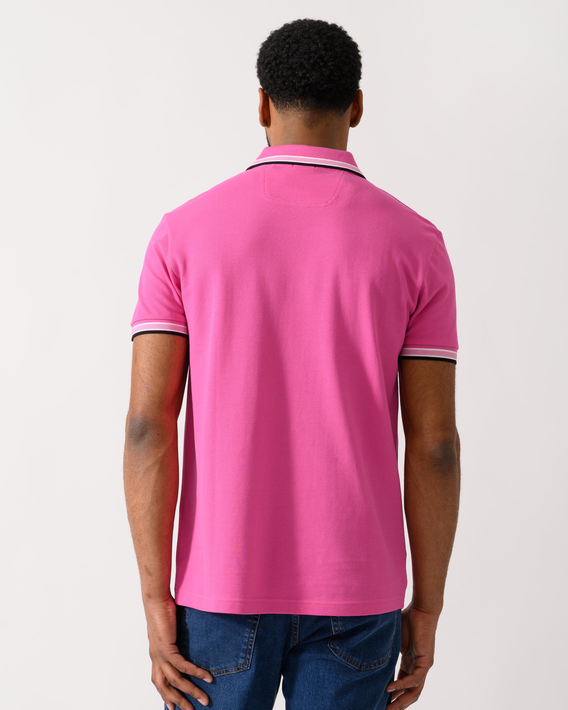 back shot of a model wearing a BOSS Green Paddy Mens Cotton-Piqué Polo Shirt with Contrast Logo in Bright Pink