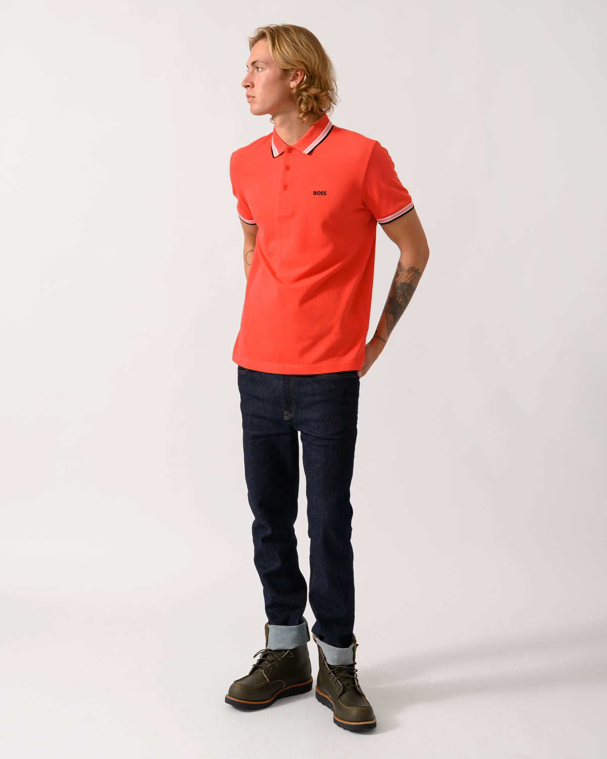 full length studio photograph of a model wearing a BOSS Green Paddy Mens Cotton-Piqué Polo Shirt with Contrast Logo in Bright Red 620