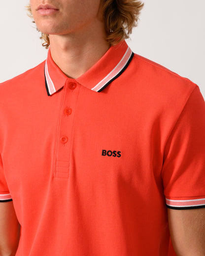 close up studio photograph of a model wearing a BOSS Green Paddy Mens Cotton-Piqué Polo Shirt with Contrast Logo in Bright Red 620