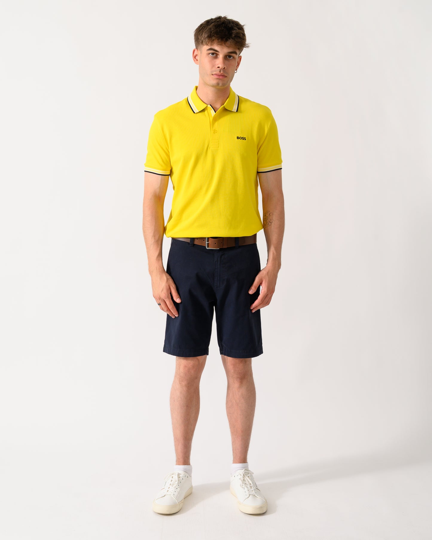 full length shot of a model wearing a BOSS Green Paddy Mens Cotton-Piqué Polo Shirt with Contrast Logo in Bright Yellow 739