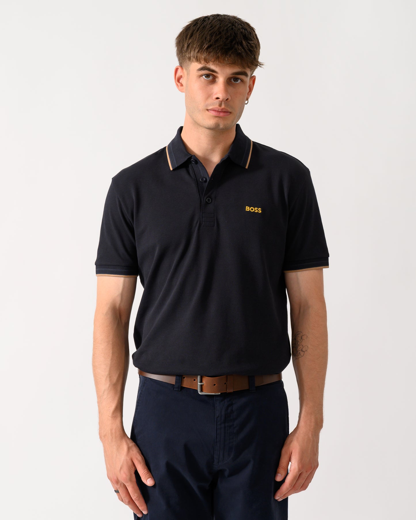 model wearing a BOSS Green Paddy Mens Cotton-Piqué Polo Shirt with Contrast Logo in Dark Blue 401