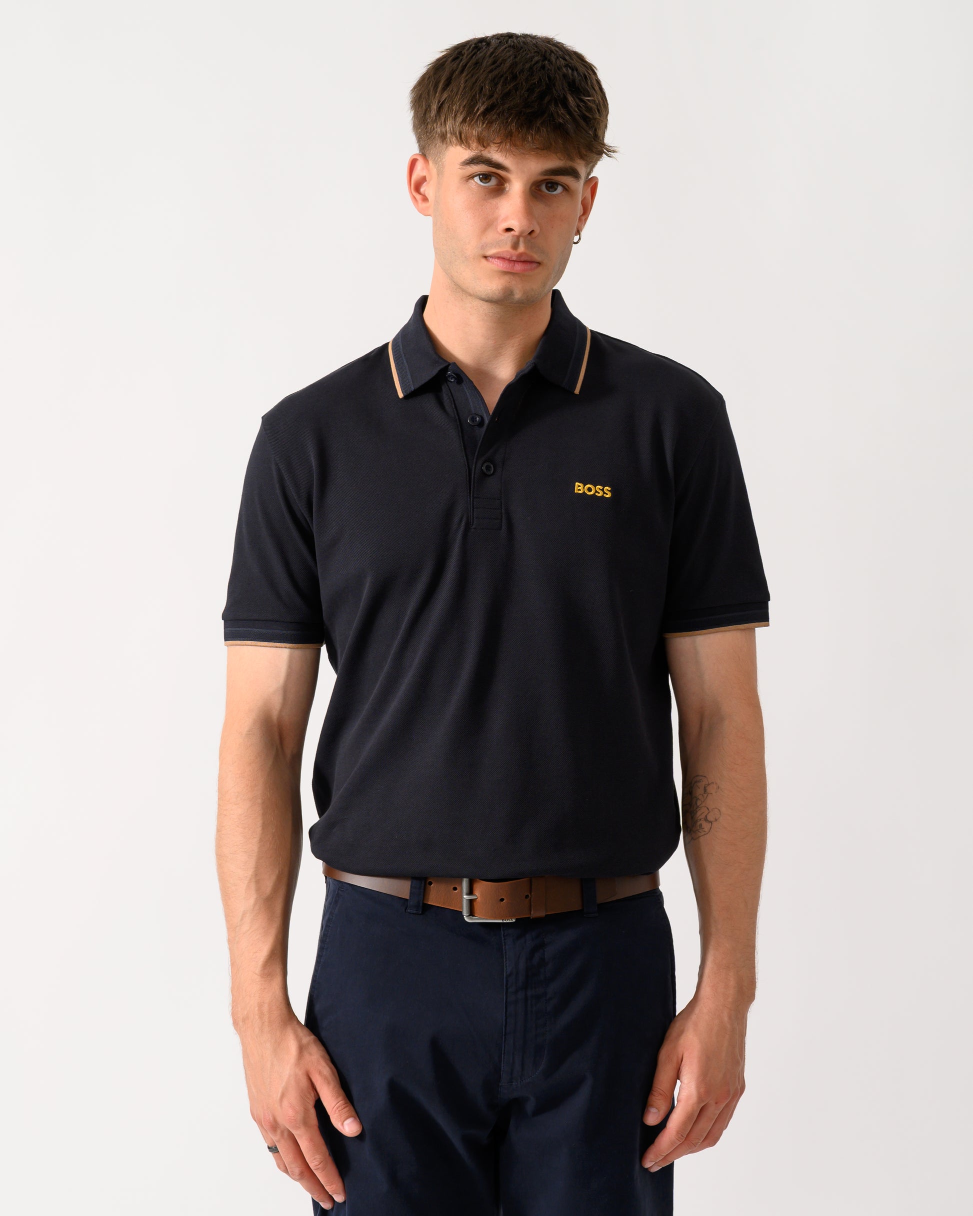 model wearing a BOSS Green Paddy Mens Cotton-Piqué Polo Shirt with Contrast Logo in Dark Blue 401