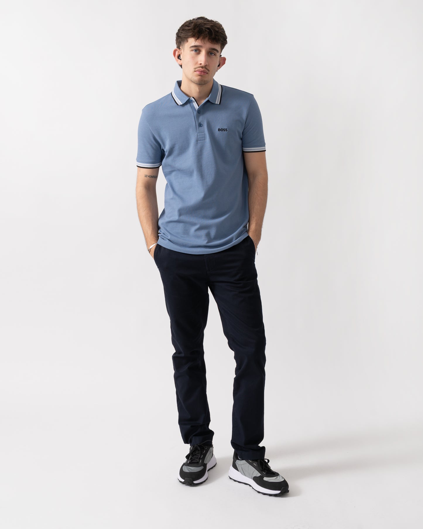 full length shot of a model wearing a BOSS Green Paddy Mens Cotton-Piqué Polo Shirt with Contrast Logo in Open Blue 462