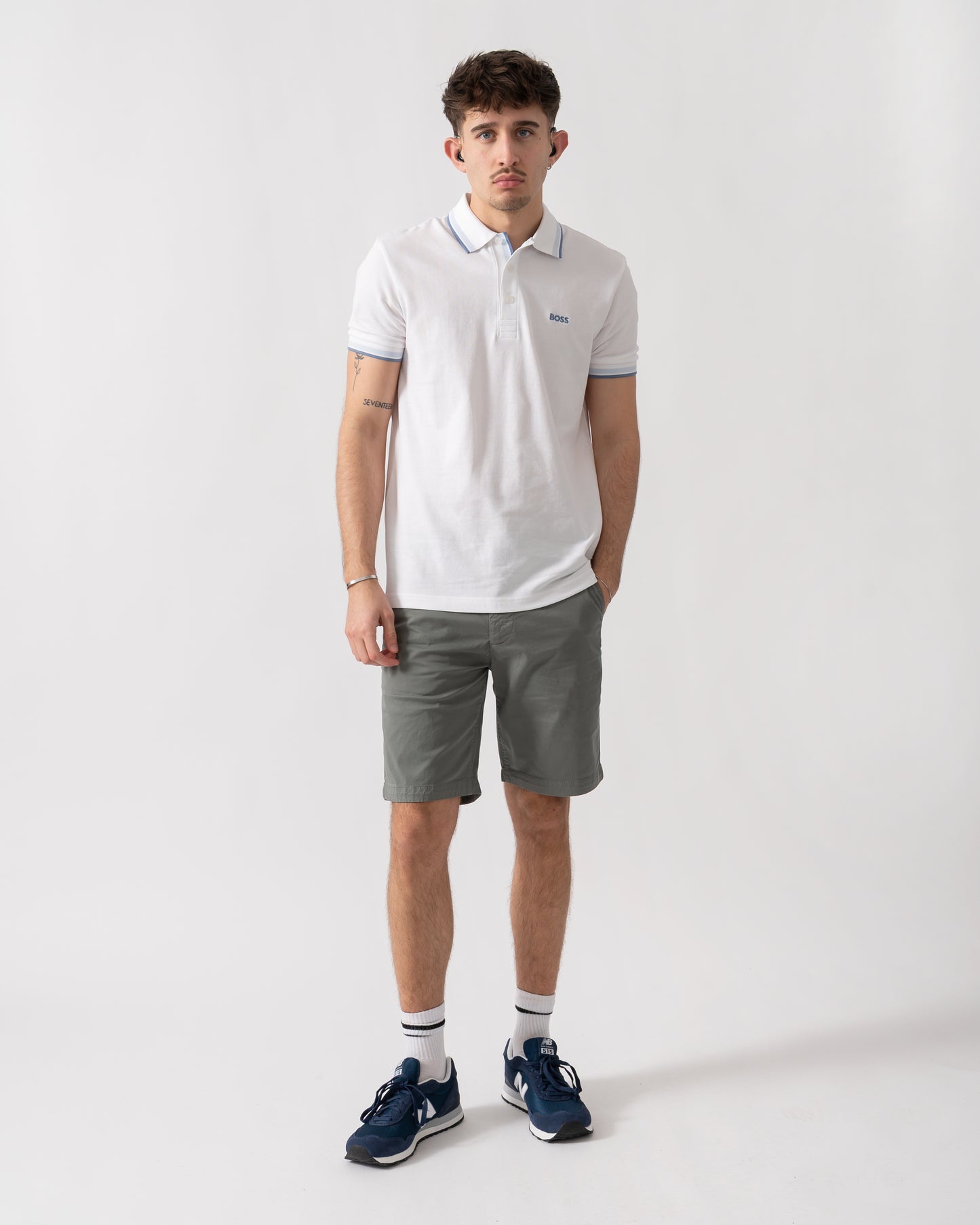 full length shot of a model wearing a BOSS Green Paddy Mens Cotton-Piqué Polo Shirt with Contrast Logo in Open White 115