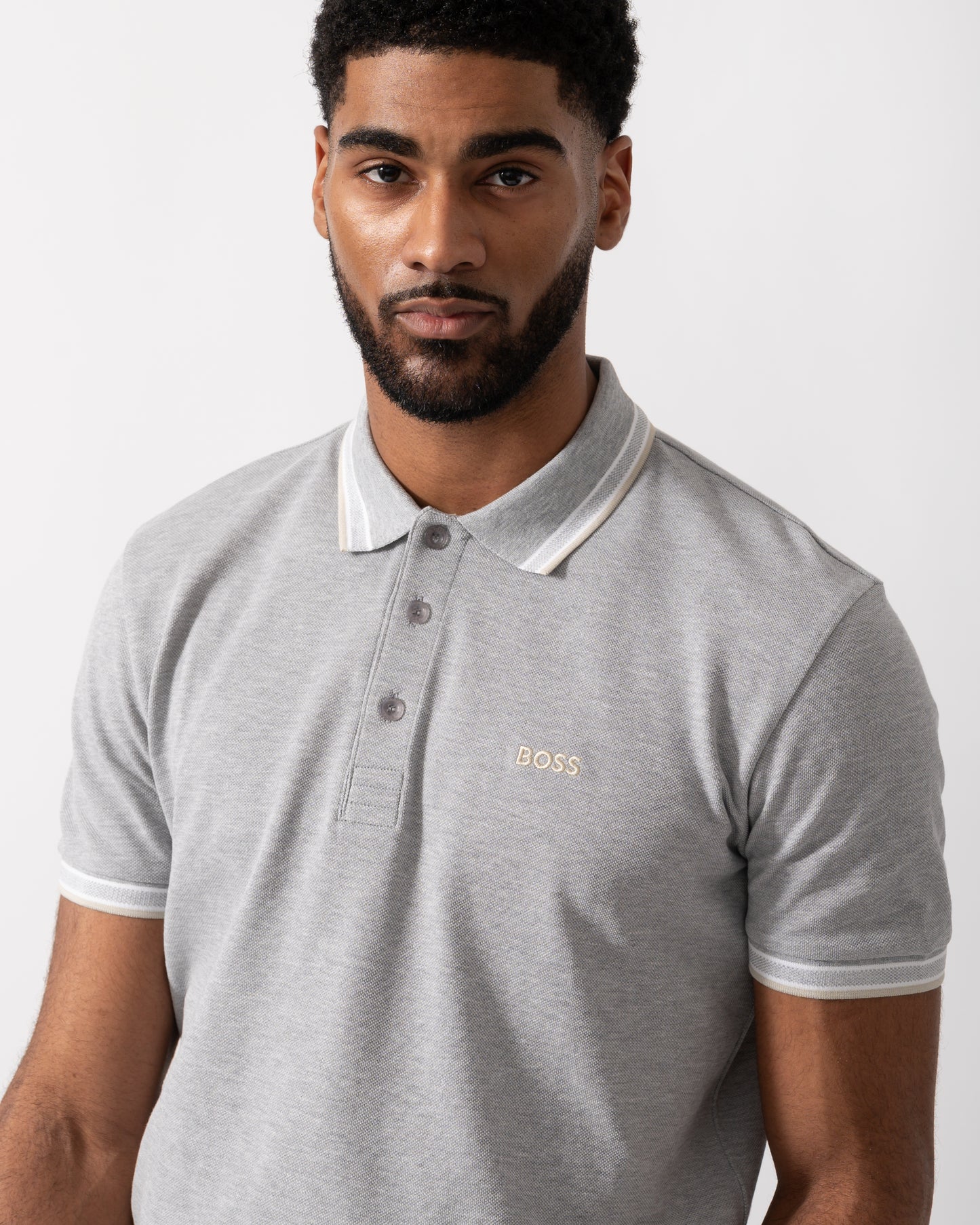 Close up shot of a Model wearing a BOSS Green Paddy Mens Cotton-Piqué Polo Shirt with Contrast Logo in Silver