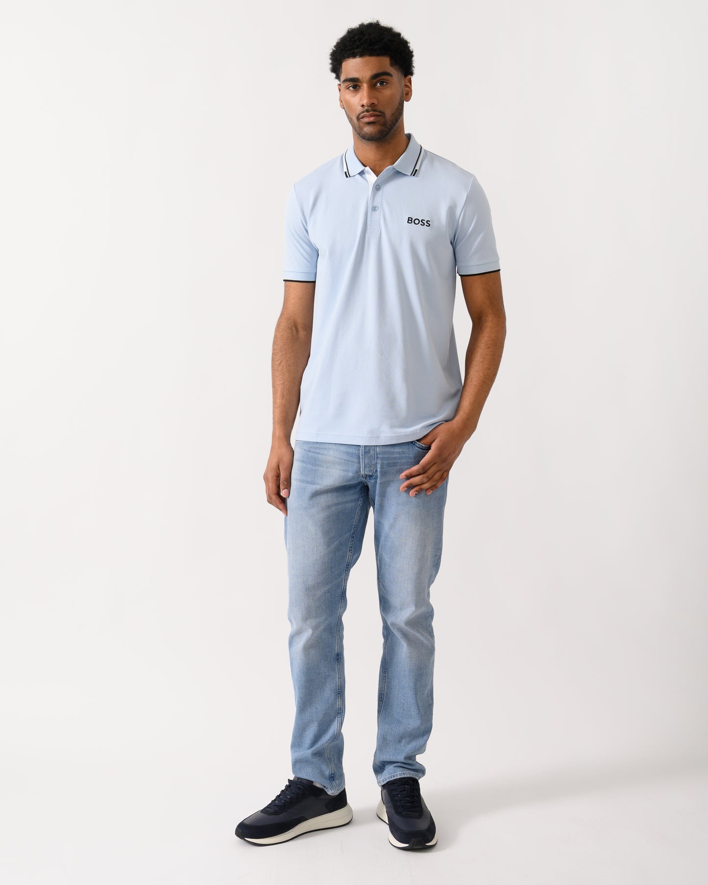 full length shot of a model wearing a BOSS Green Paddy Pro Mens Cotton Blend Polo Shirt With Contrast Logos in Open Blue 460