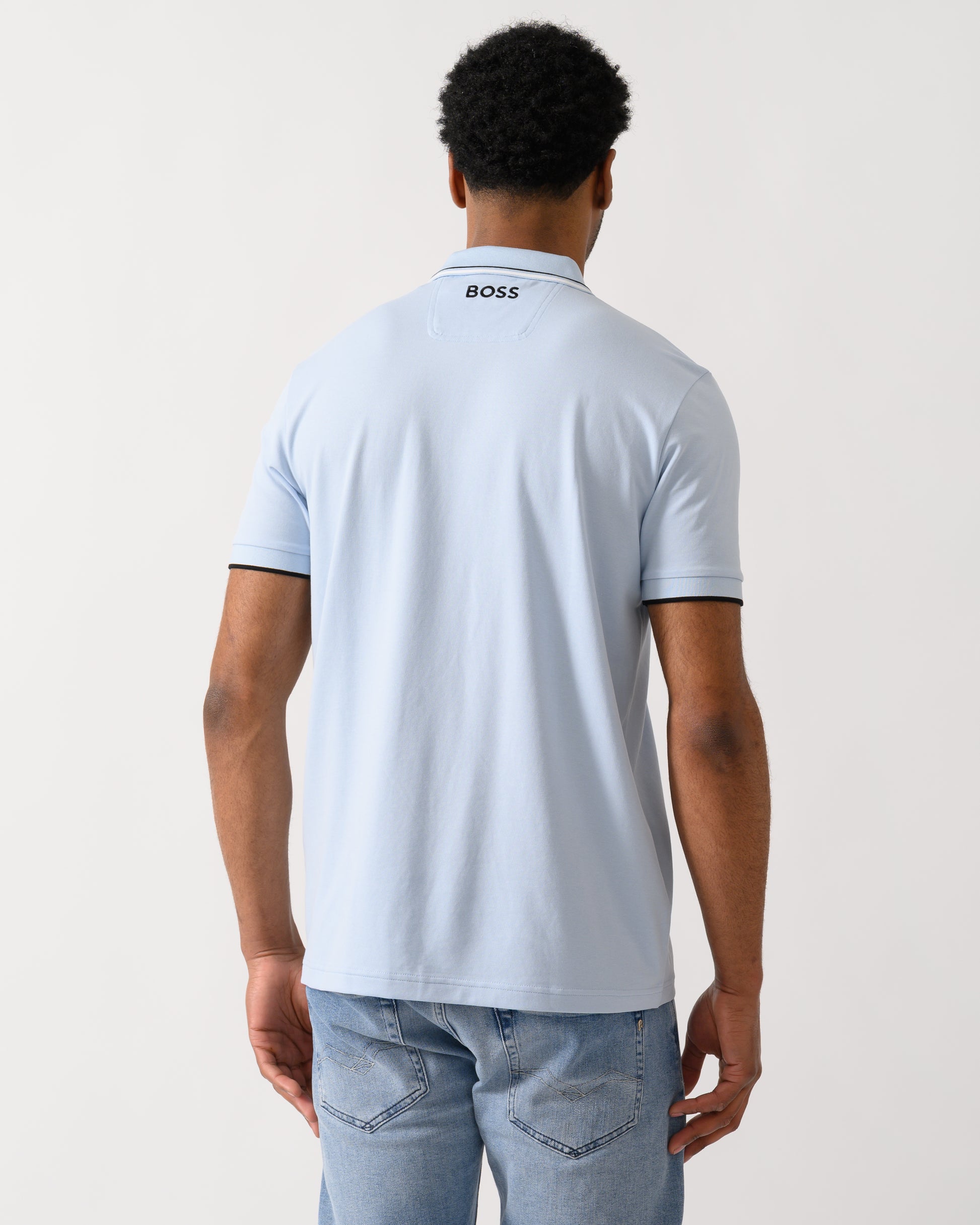 back shot of a model wearing a BOSS Green Paddy Pro Mens Cotton Blend Polo Shirt With Contrast Logos in Open Blue 460