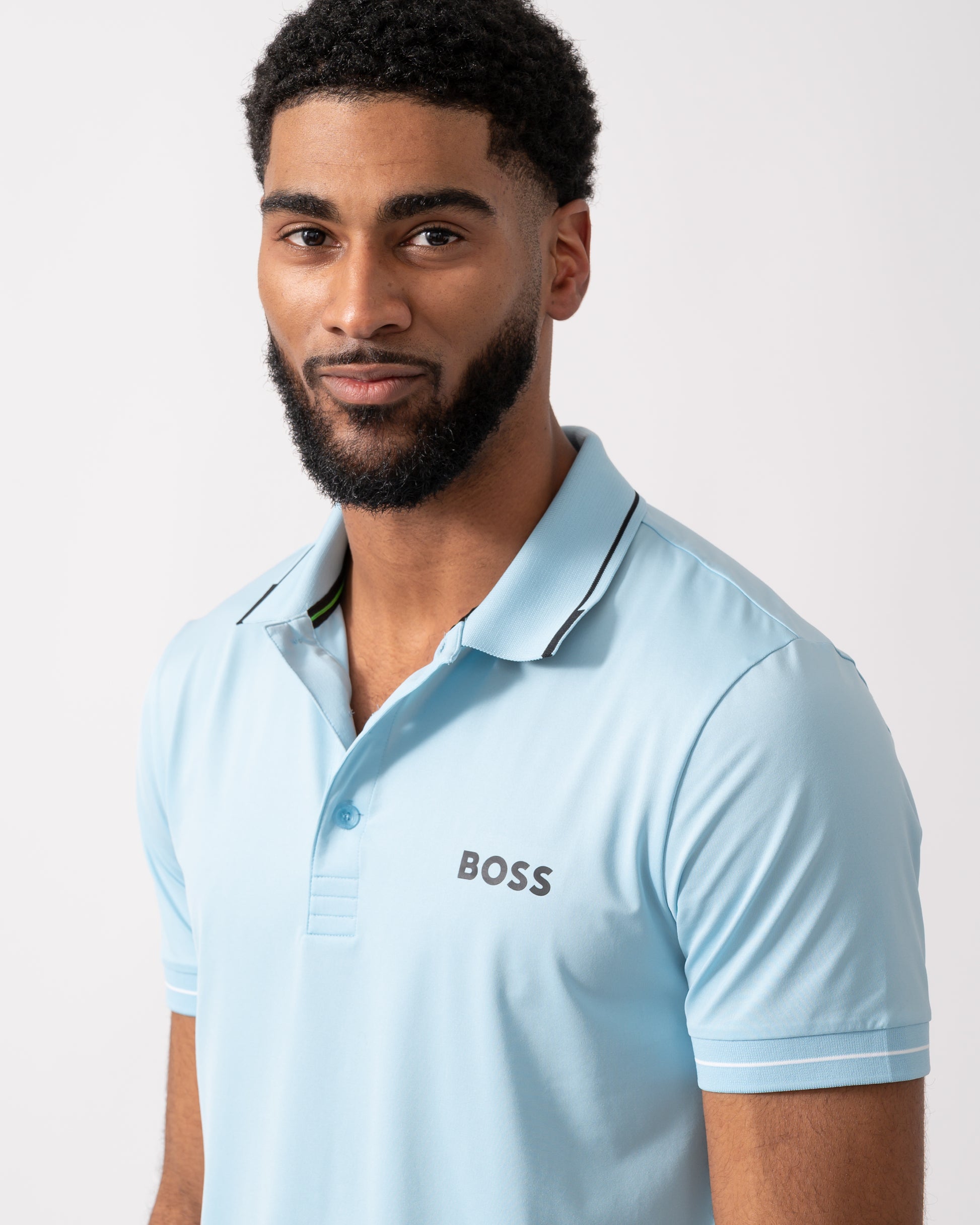 Close up of a model wearing a BOSS Green Paul Pro Mens Tipped Polo Shirt in Light Pastel Blue
