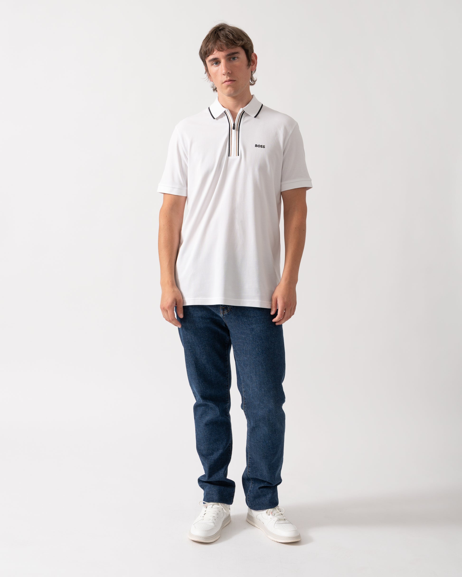full length of a model wearing a BOSS Green Philix Mens Slim Fit Zip Polo Shirt in Moisture-Wicking Stretch Cotton White 100