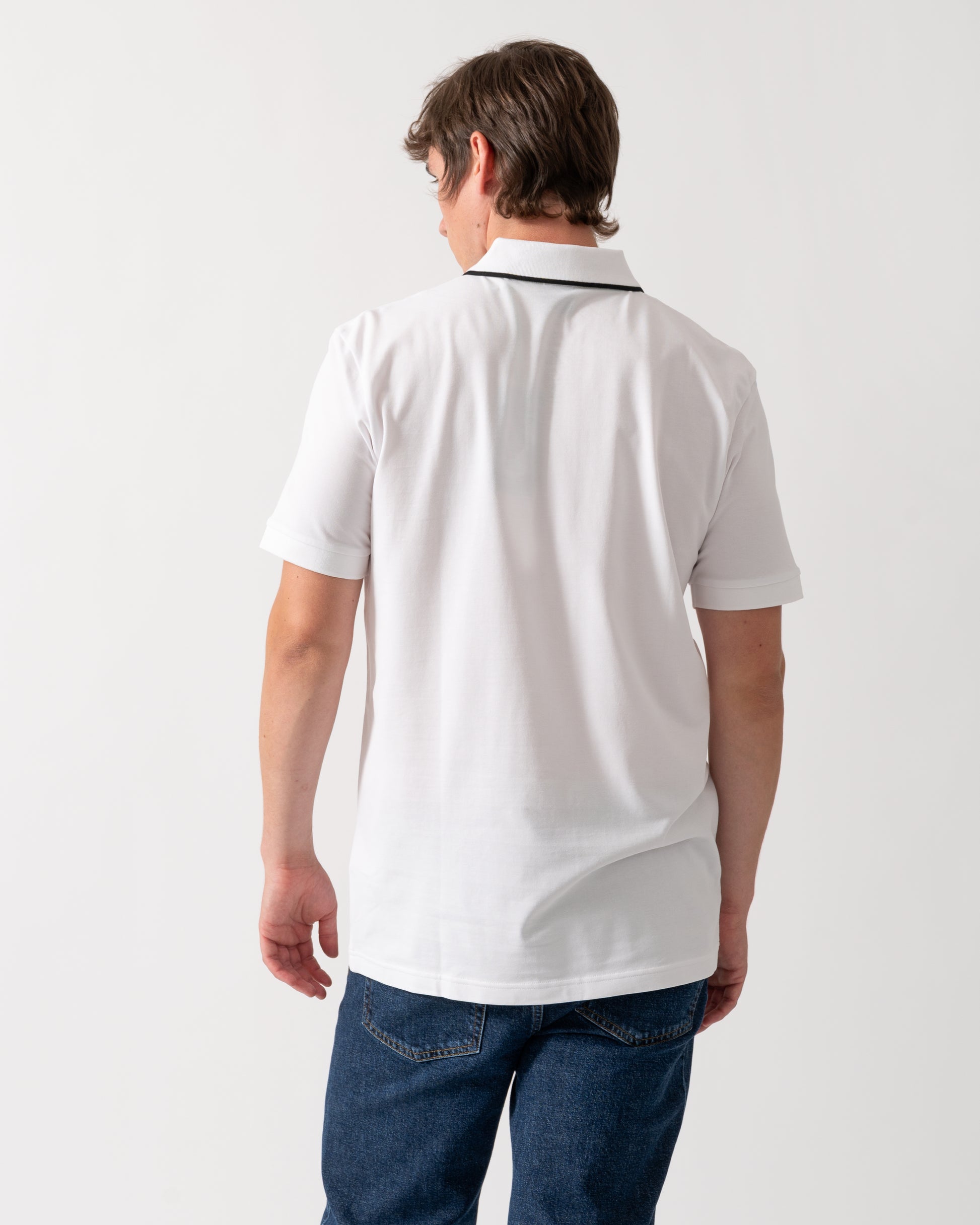back of a model wearing a BOSS Green Philix Mens Slim Fit Zip Polo Shirt in Moisture-Wicking Stretch Cotton White 100