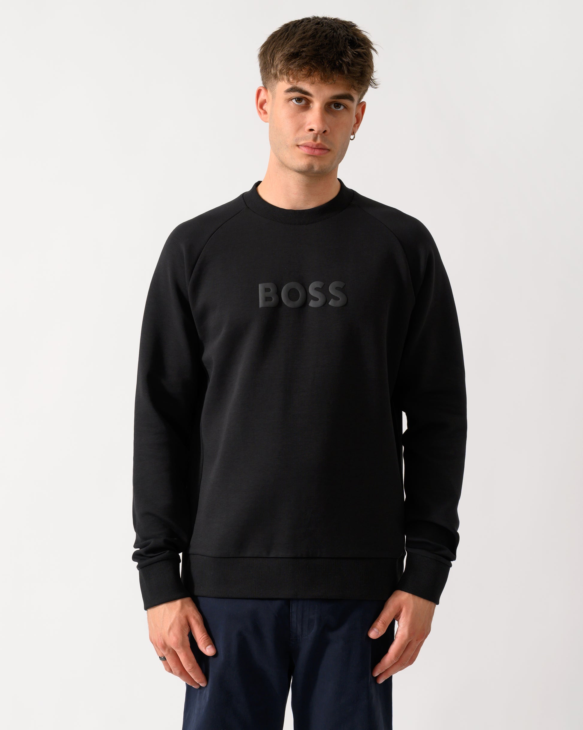 model wearing a BOSS Green Salbo Mens Crew Neck Sweatshirt with Tonal Logo in Black 001