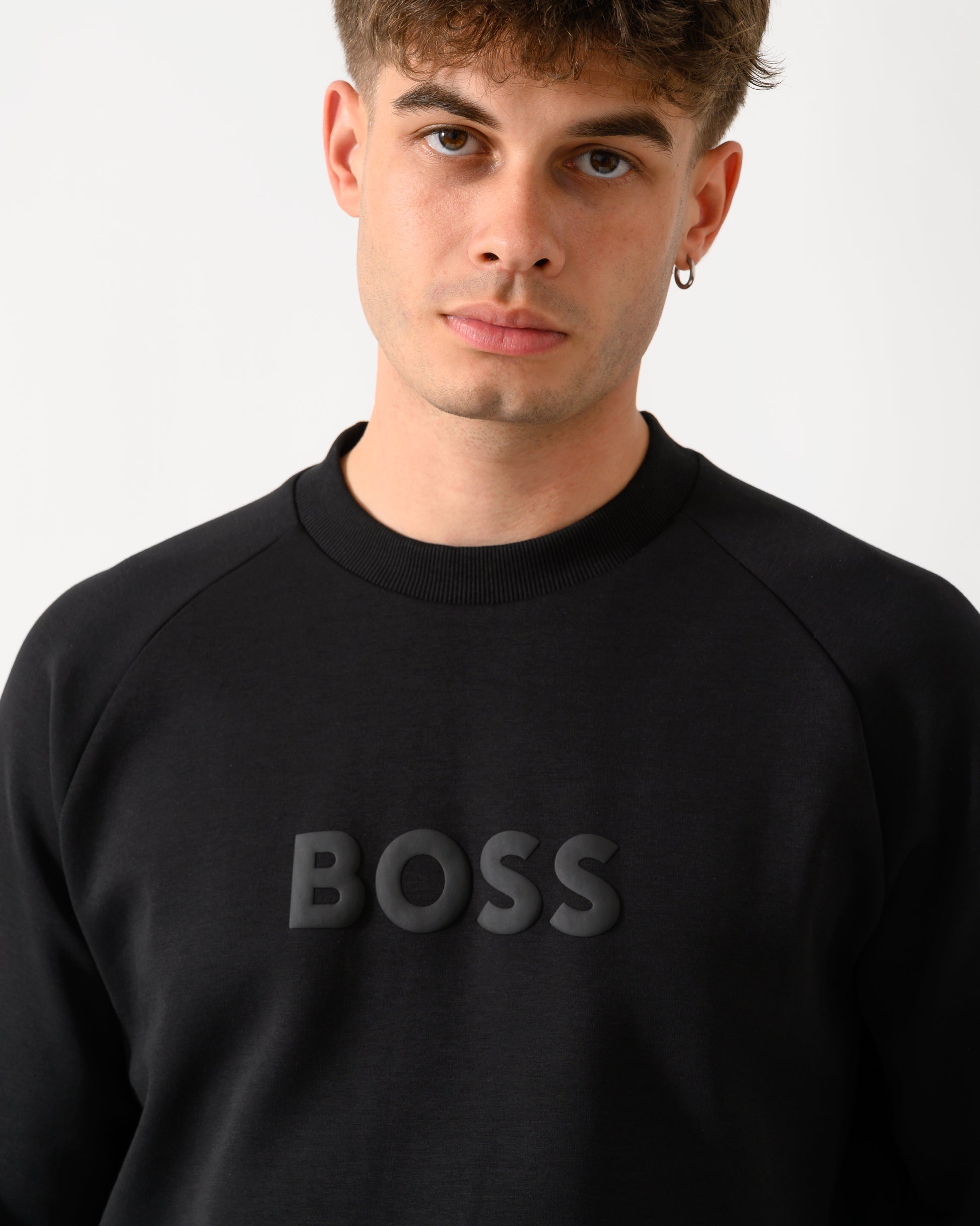 close up shot of a model wearing a BOSS Green Salbo Mens Crew Neck Sweatshirt with Tonal Logo in Black 001