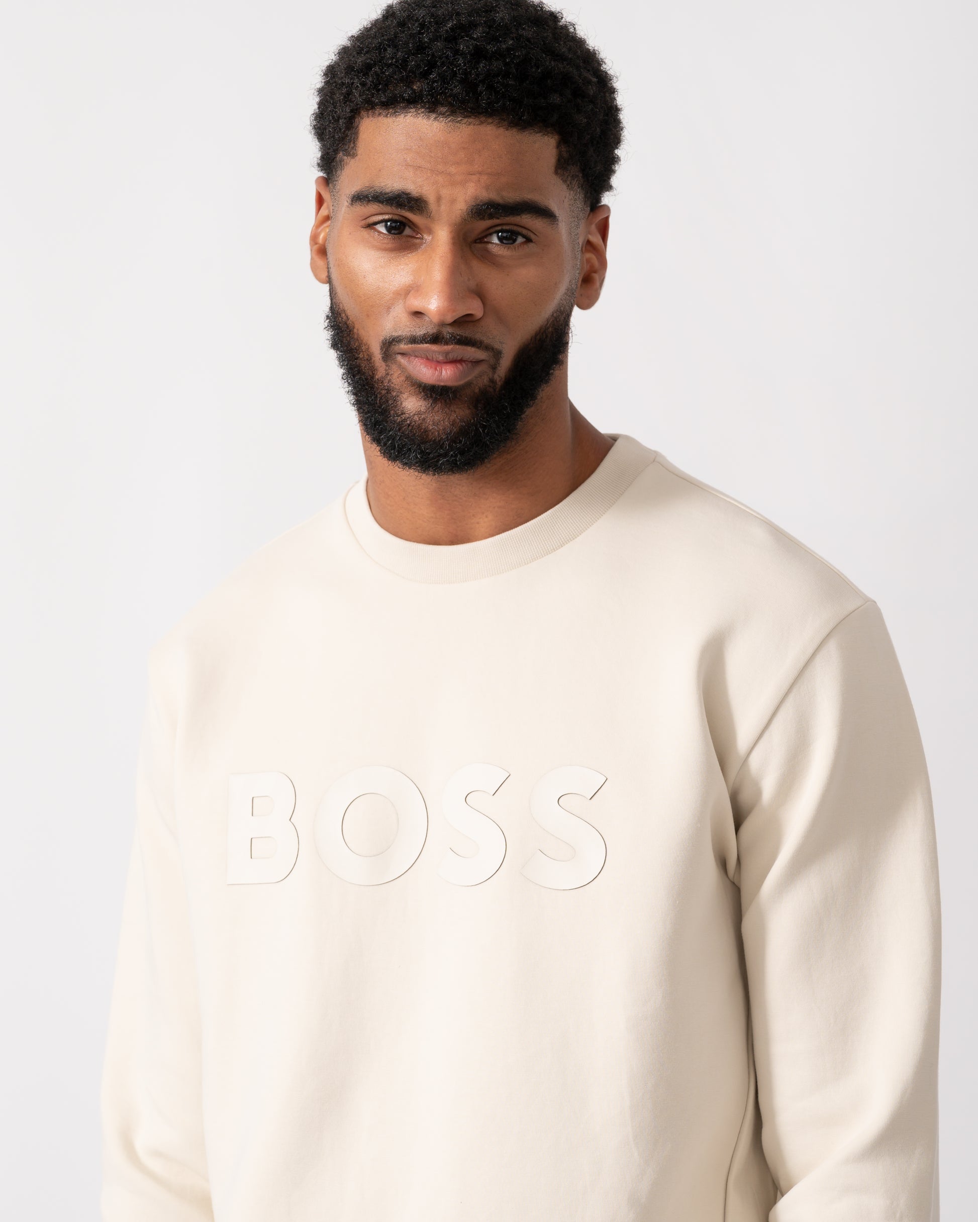 close up of a Model wearing a BOSS Green Salbo Mens Stretch-Cotton Sweatshirt with Sandwich Print Logo in Open White