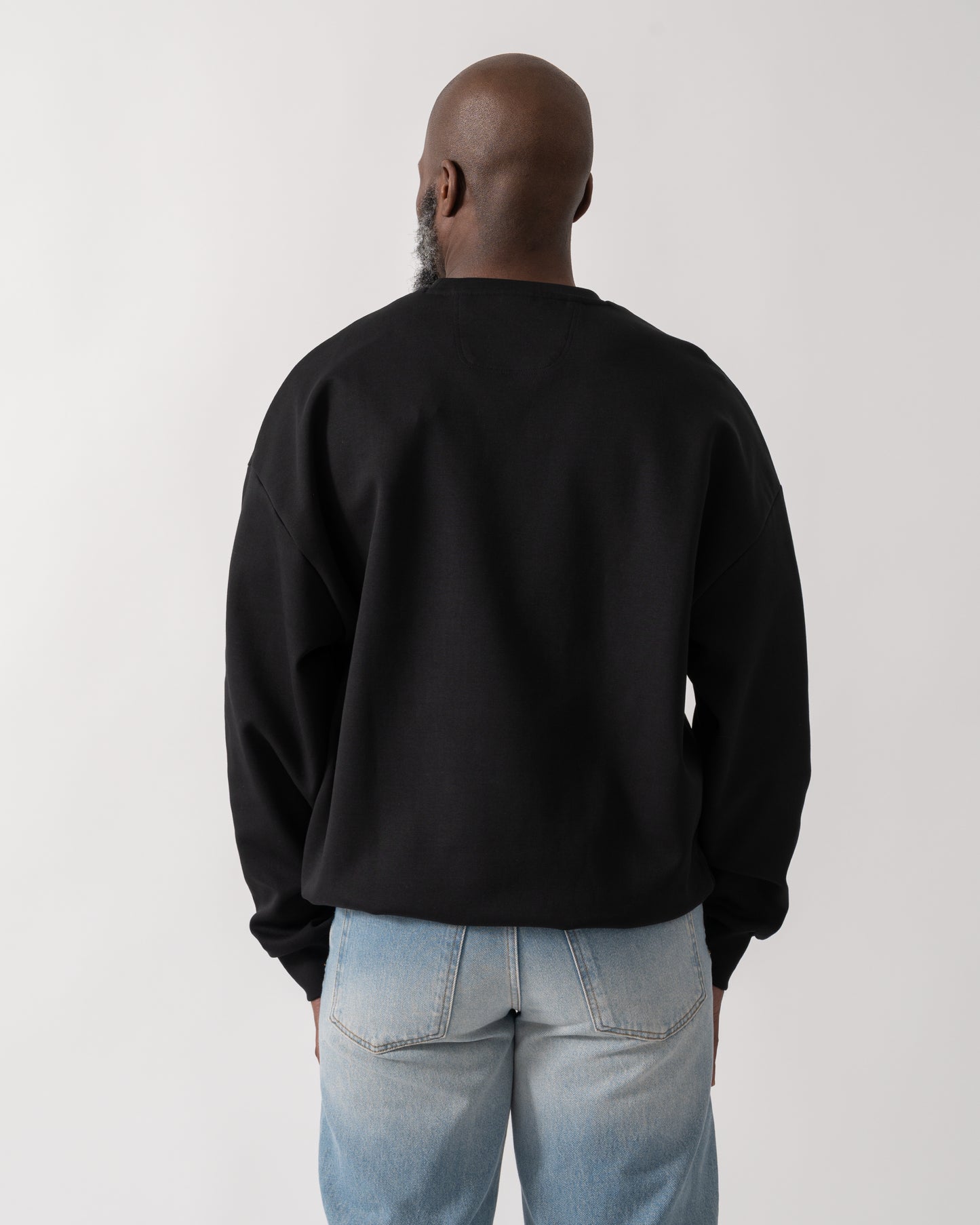 back shot of a Model wearing a BOSS Green Stenson Mens Crew Neck Sweatshirt in Black
