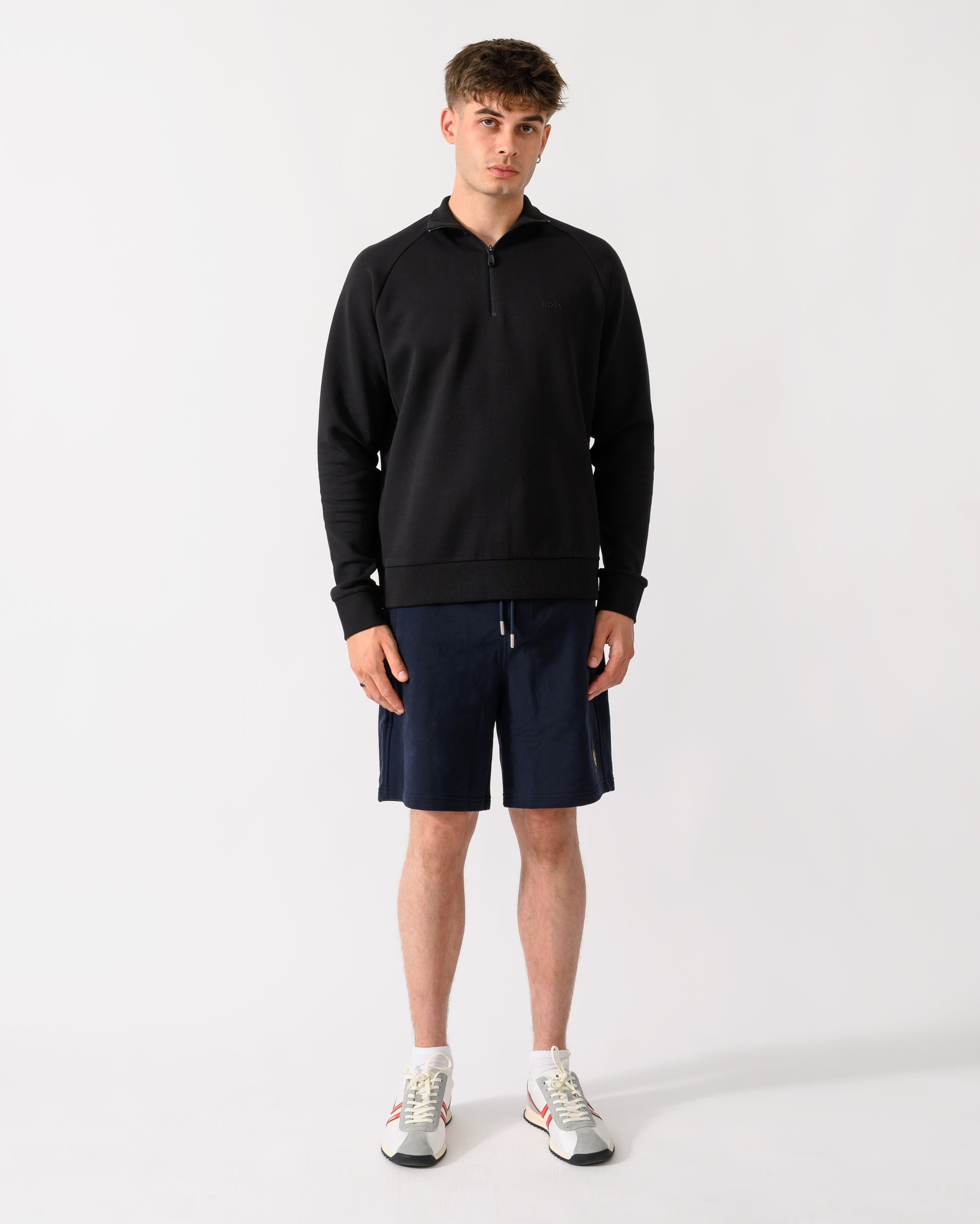 full length shot of a model wearing a BOSS Green Sweat Mens 1/4 Zip Sweatshirt in Black 001