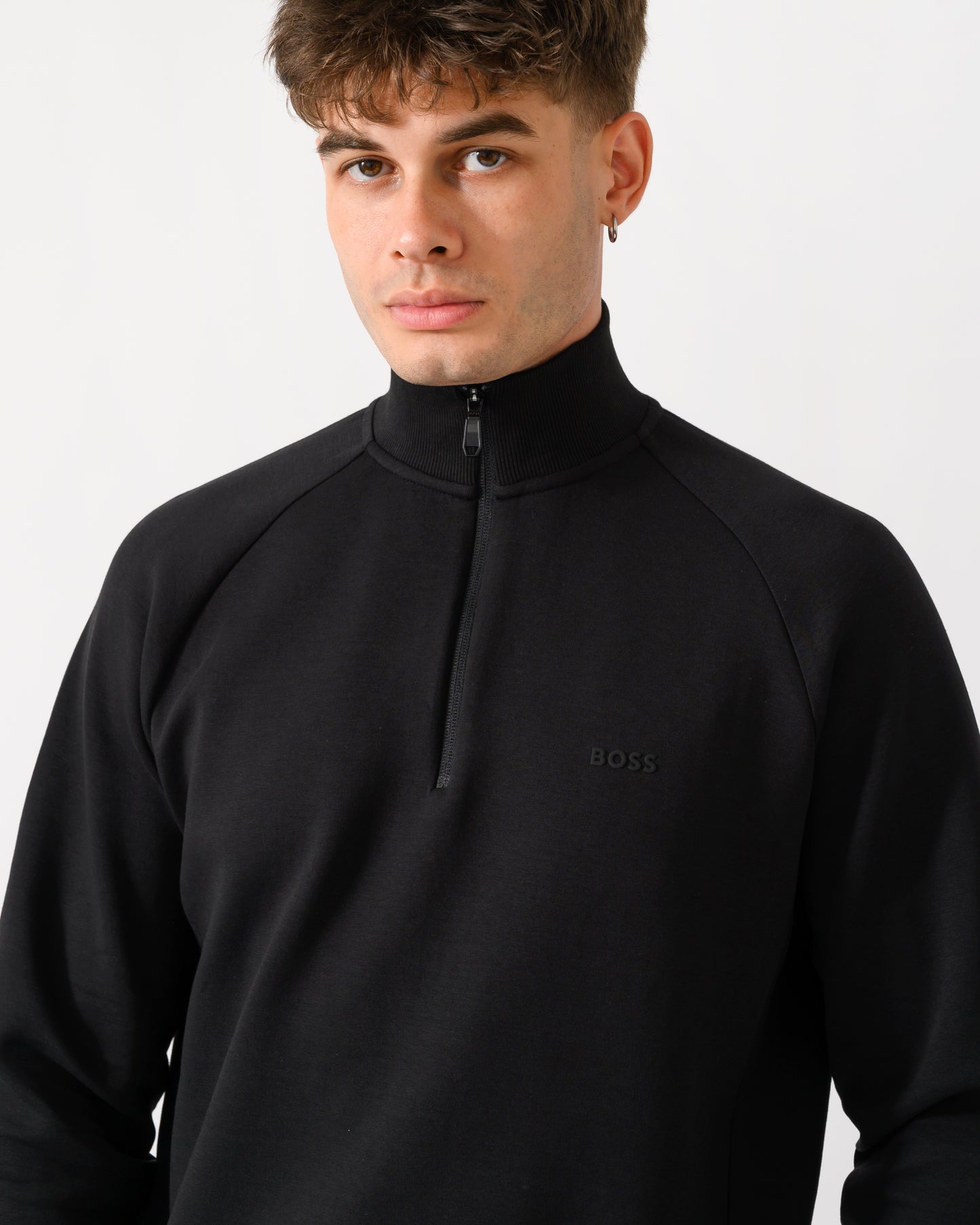 close up shot of a model wearing a BOSS Green Sweat Mens 1/4 Zip Sweatshirt in Black 001