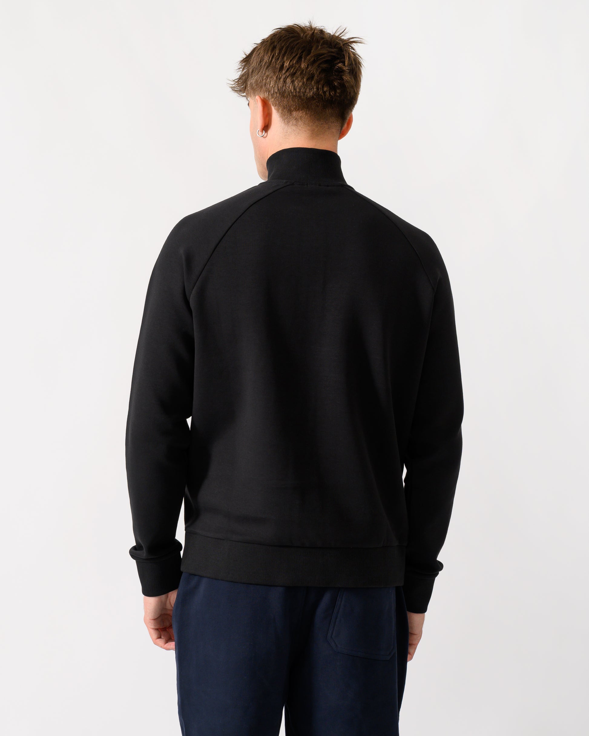 back shot of a model wearing a BOSS Green Sweat Mens 1/4 Zip Sweatshirt in Black 001