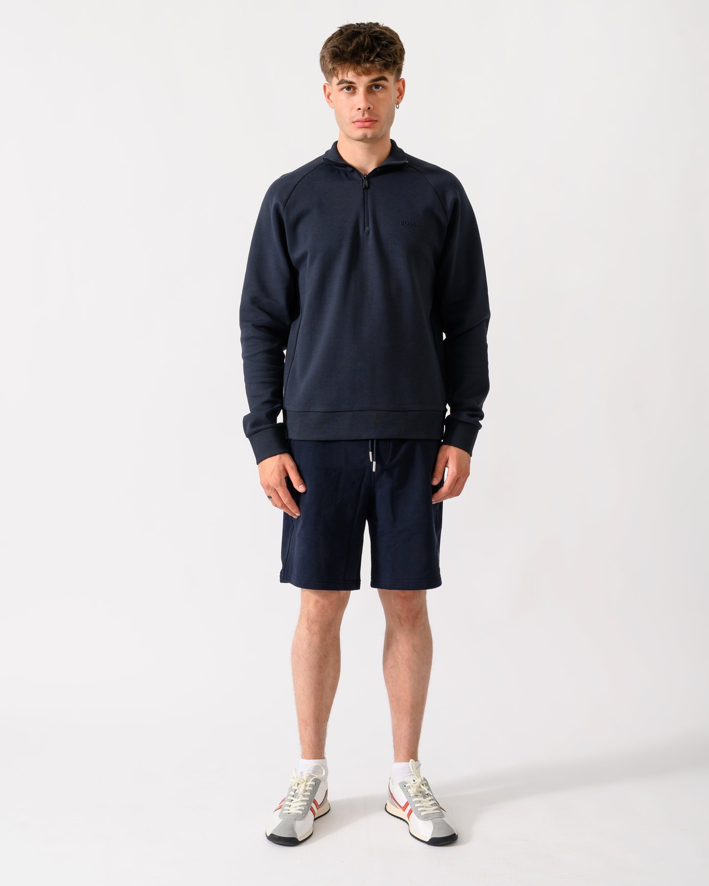 full length shot of a model wearing a BOSS Green Sweat Mens quarter Zip Sweatshirt in Dark Blue 402