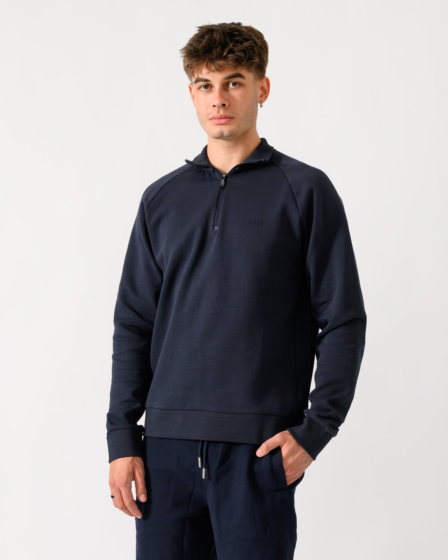mid shot of a model wearing a BOSS Green Sweat Mens quarter Zip Sweatshirt in Dark Blue 402