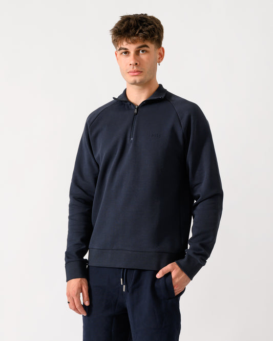 mid shot of a model wearing a BOSS Green Sweat Mens quarter Zip Sweatshirt in Dark Blue 402