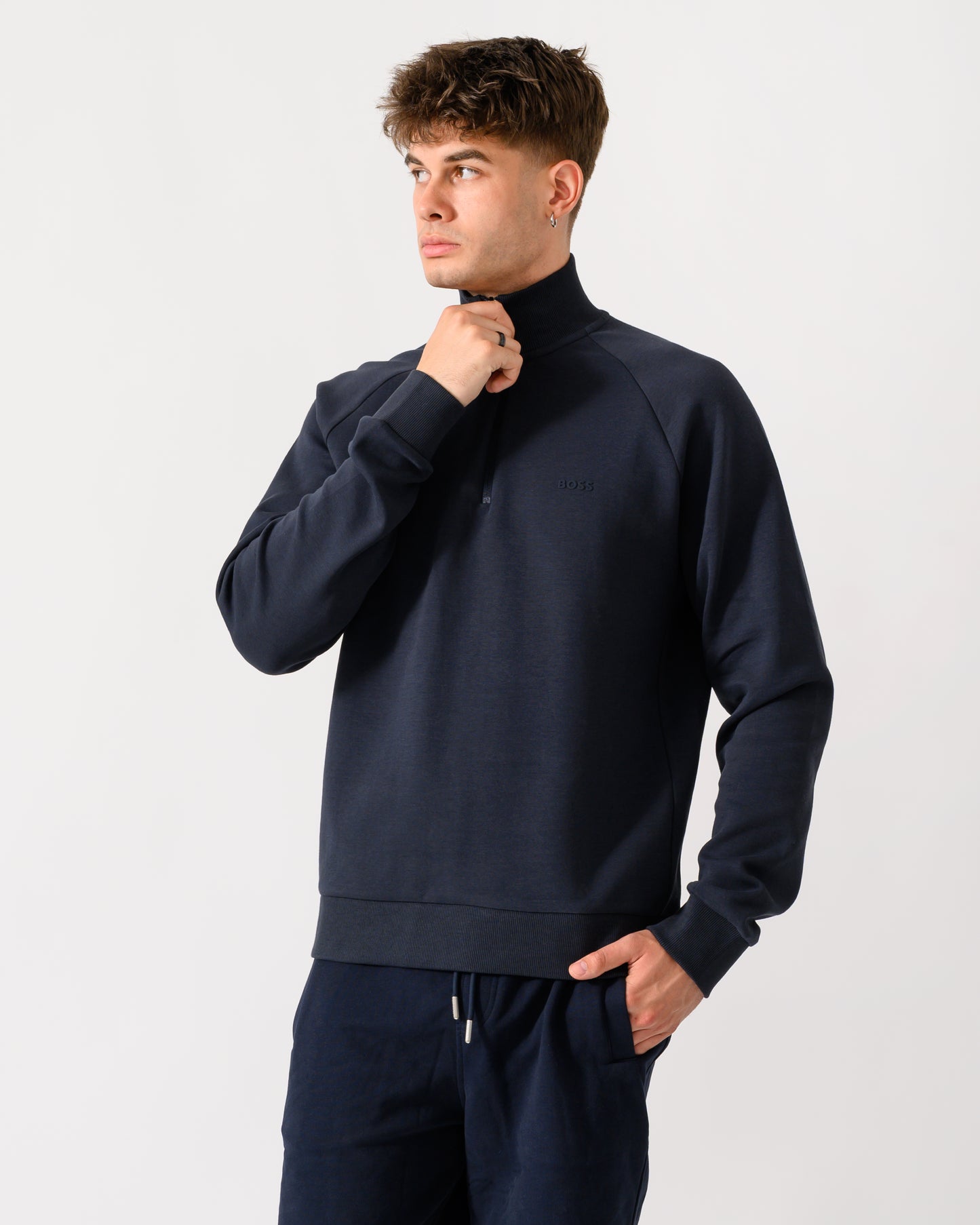 model wearing a BOSS Green Sweat Mens quarter Zip Sweatshirt in Dark Blue 402