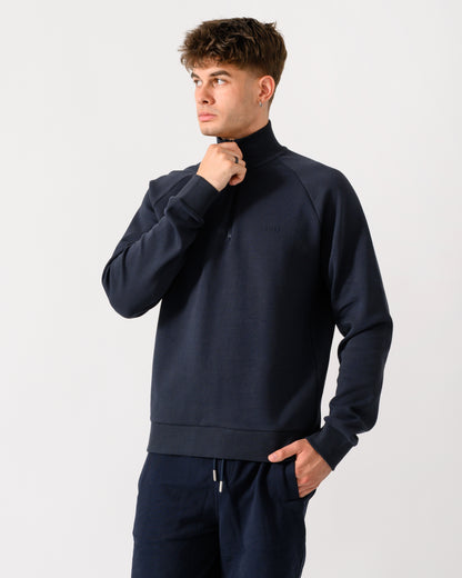 model wearing a BOSS Green Sweat Mens quarter Zip Sweatshirt in Dark Blue 402