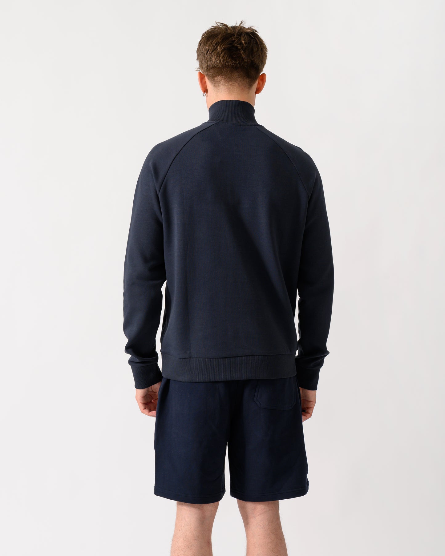 back shot of a model wearing a BOSS Green Sweat Mens quarter Zip Sweatshirt in Dark Blue 402