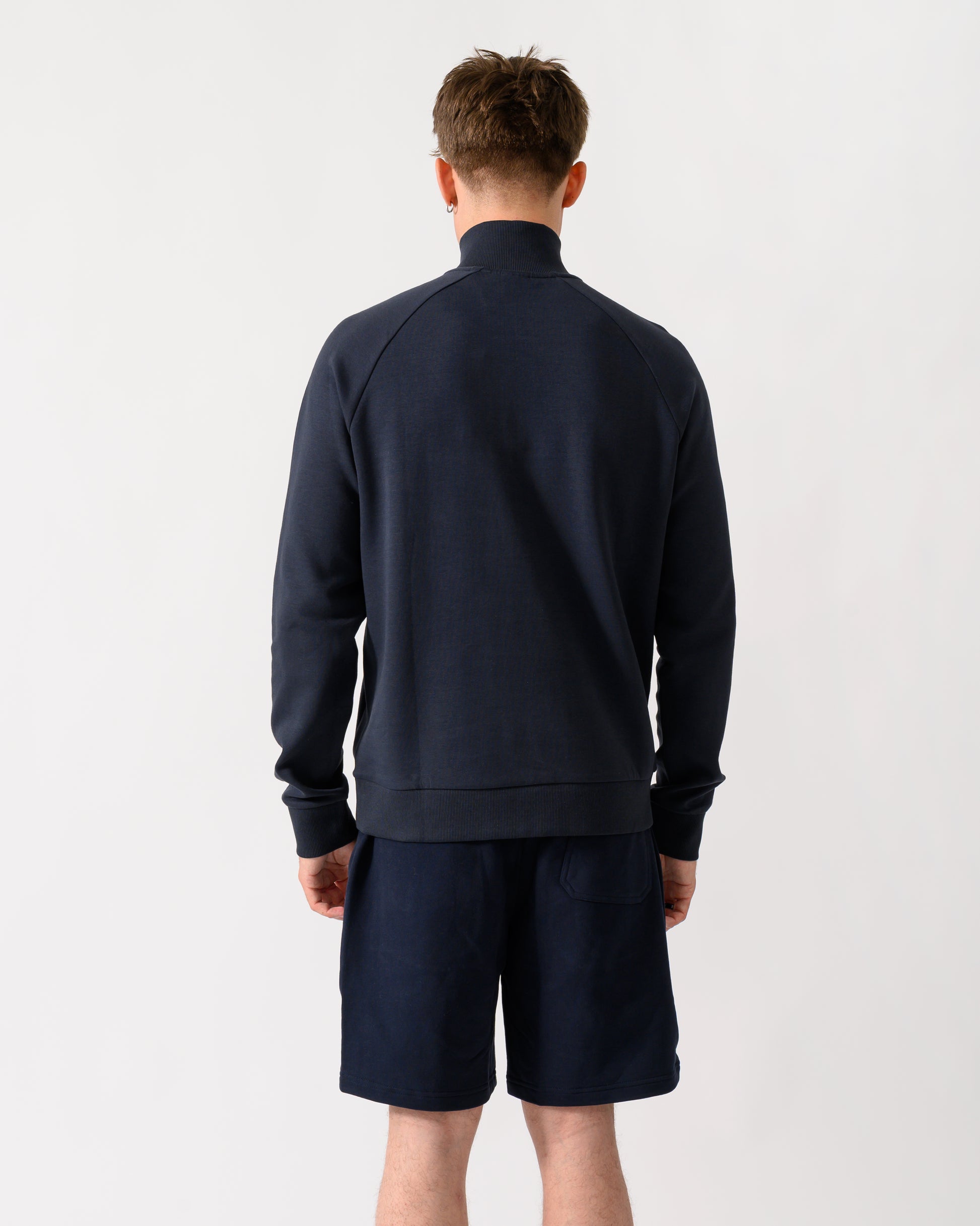 back shot of a model wearing a BOSS Green Sweat Mens quarter Zip Sweatshirt in Dark Blue 402