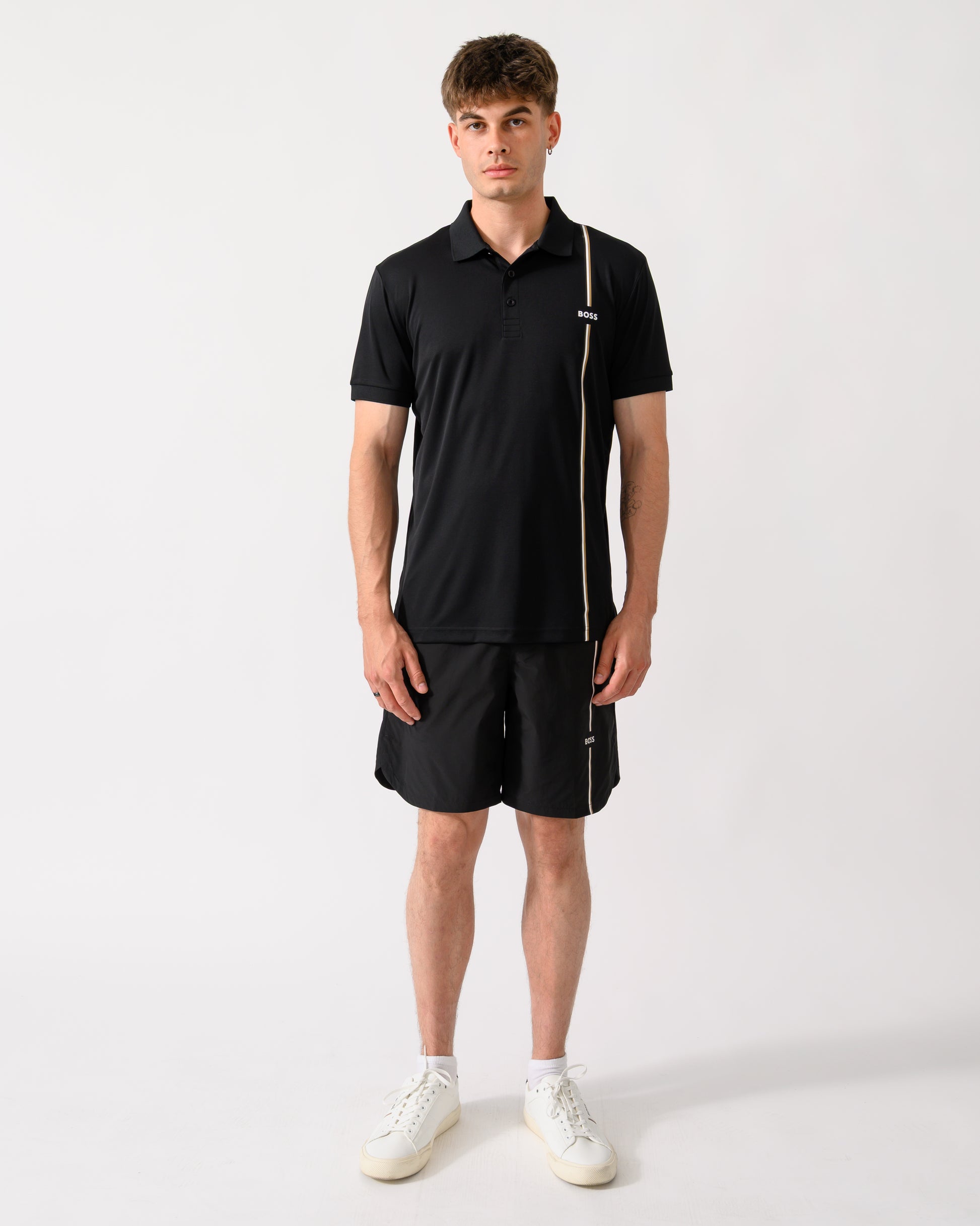 full length shot of a model wearing a BOSS Green TOC Game Mens Polo Shirt in Black 001