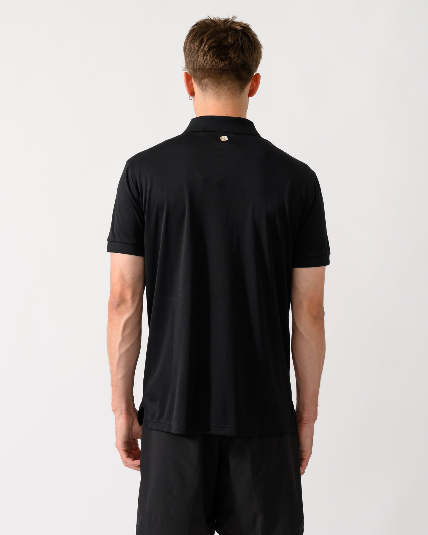 back shot of a model wearing a BOSS Green TOC Game Mens Polo Shirt in Black 001