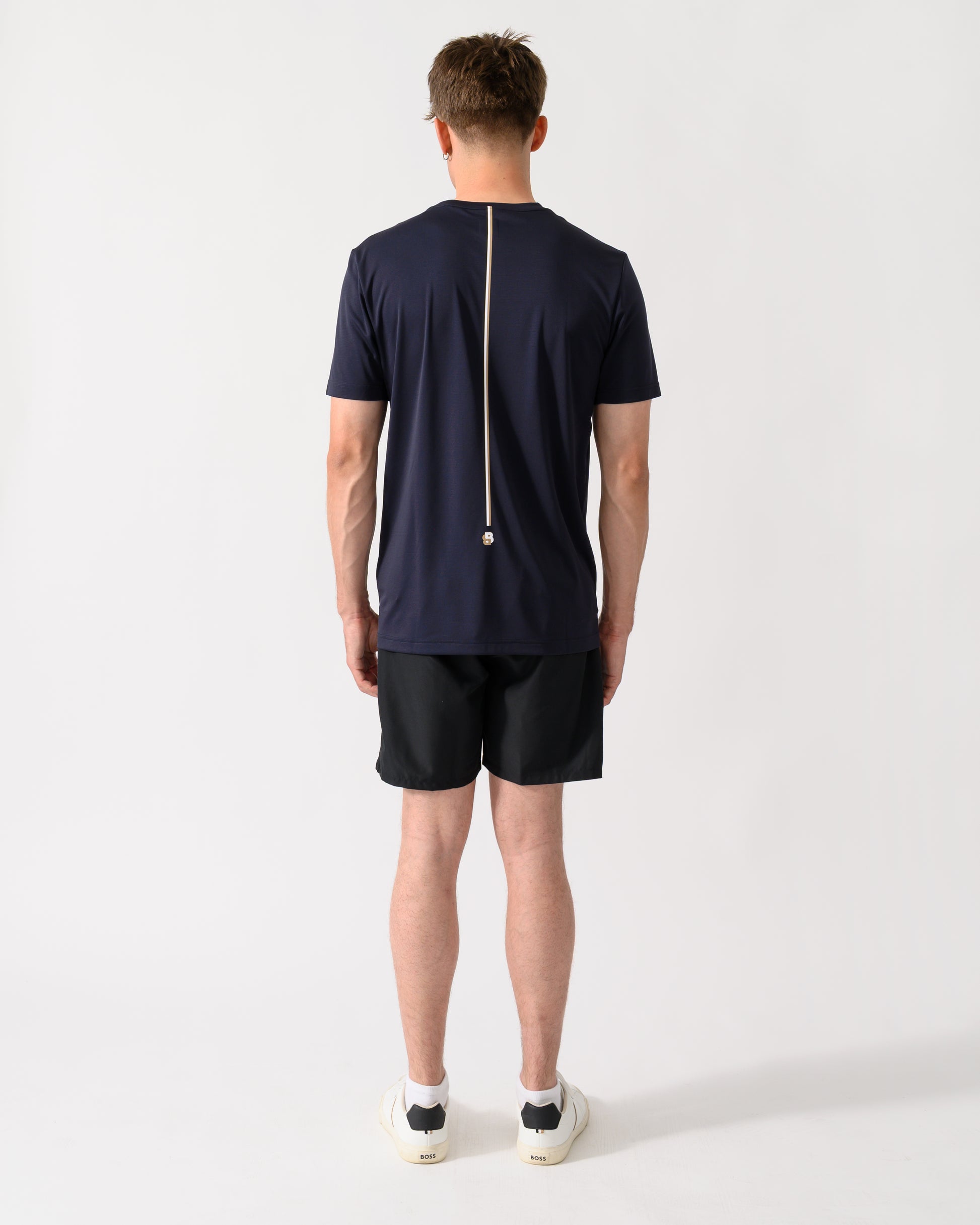 back shot of a model wearing a BOSS Green TOC Game Mens T-Shirt in Dark Blue 402