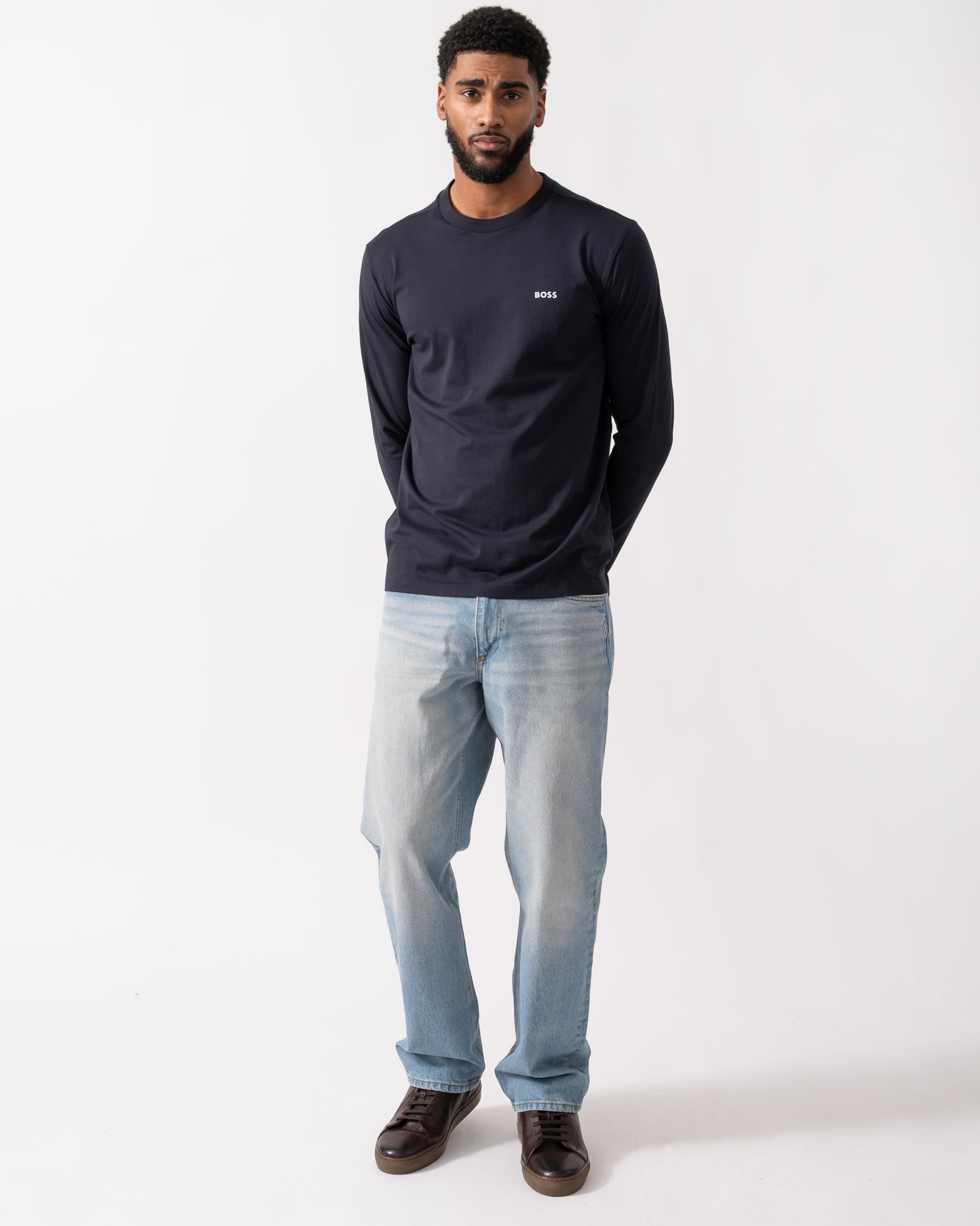 full length of a model wearing a BOSS Green Tee Mens Stretch-Cotton T-Shirt with Contrast Logo in Dark Blue