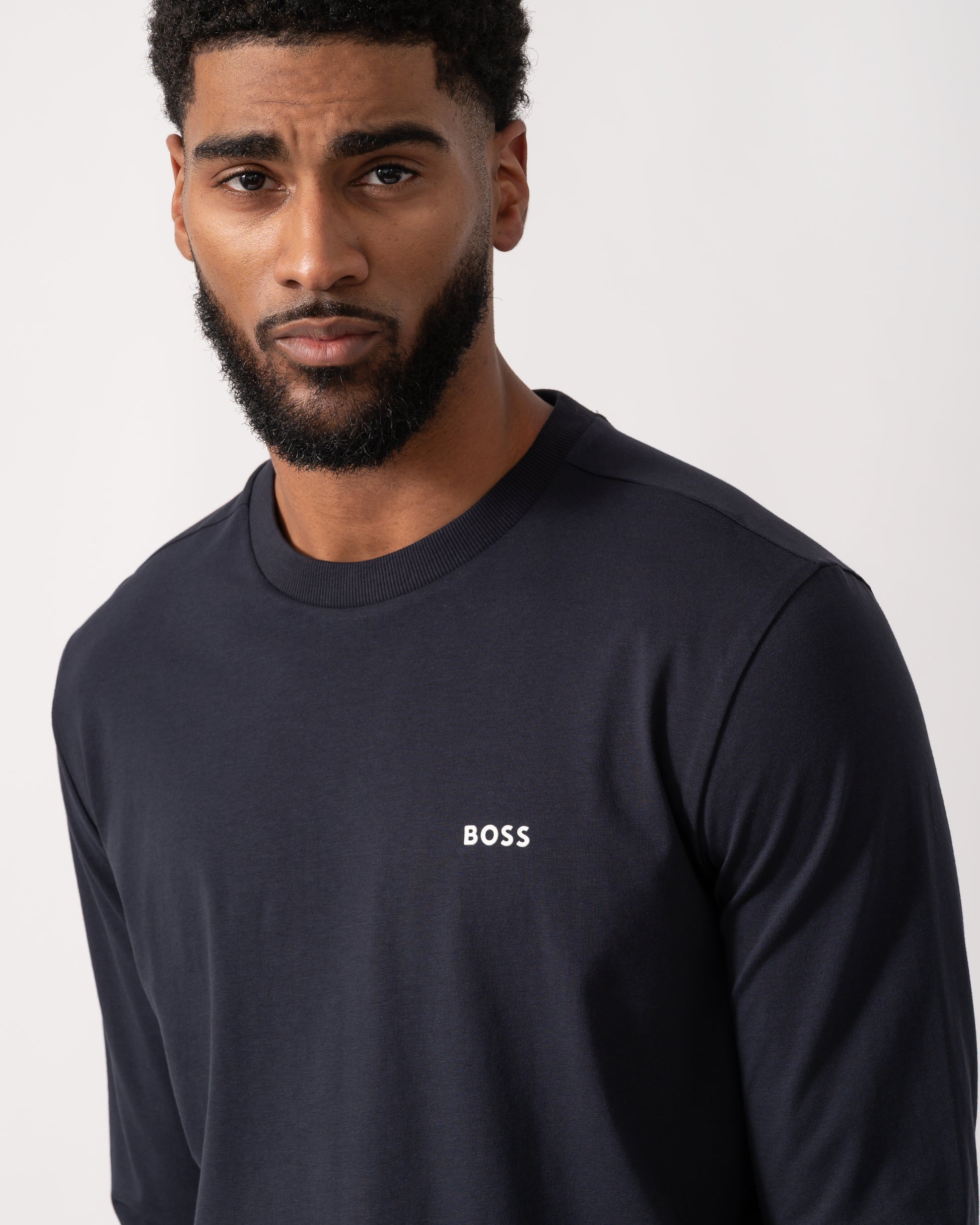 close up shot of a model wearing a BOSS Green Tee Mens Stretch-Cotton T-Shirt with Contrast Logo in Dark Blue