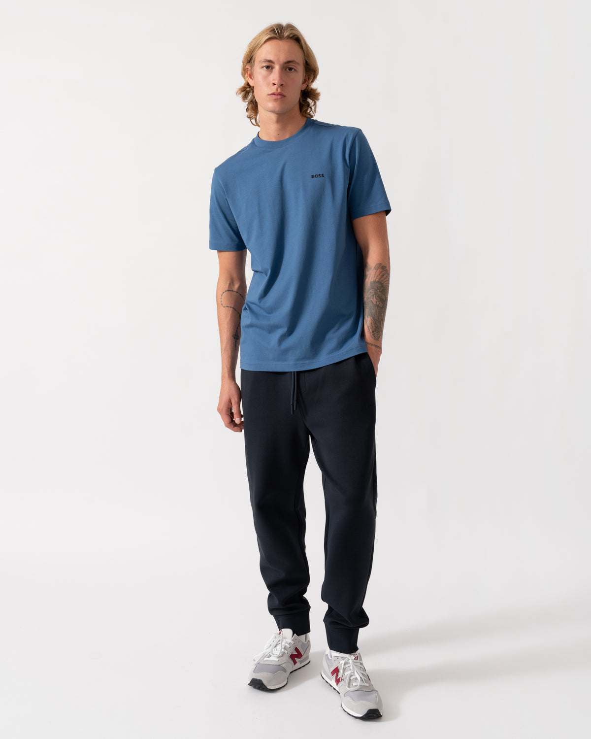 Model wearing the BOSS Green Hadiko Mens Stretch-cotton track pants with puff-print logo - Dark Blue 402