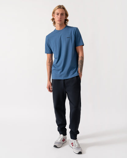 Model wearing the BOSS Green Hadiko Mens Stretch-cotton track pants with puff-print logo - Dark Blue 402