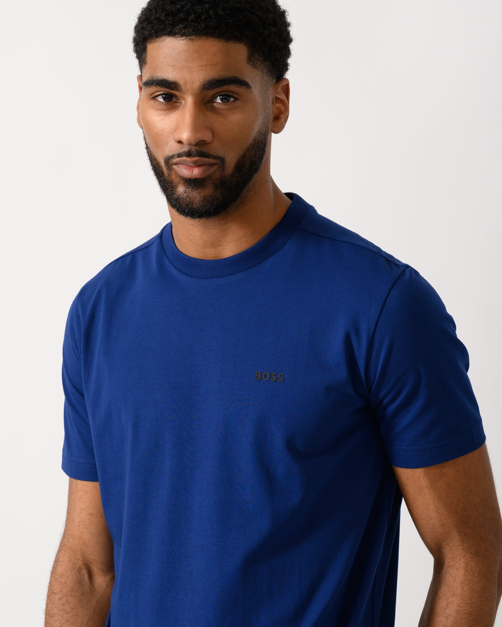 detail shot of a model wearing a BOSS Green Tee Mens Stretch Cotton T-Shirt with Contrast Logo in Navy