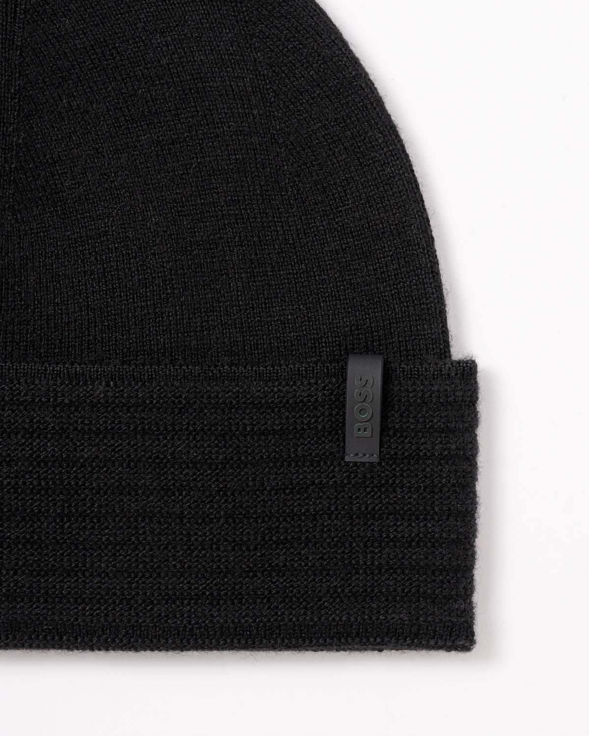 studio photograph showing the logo detail of a BOSS Green Termix Mens Beanie in Black 001