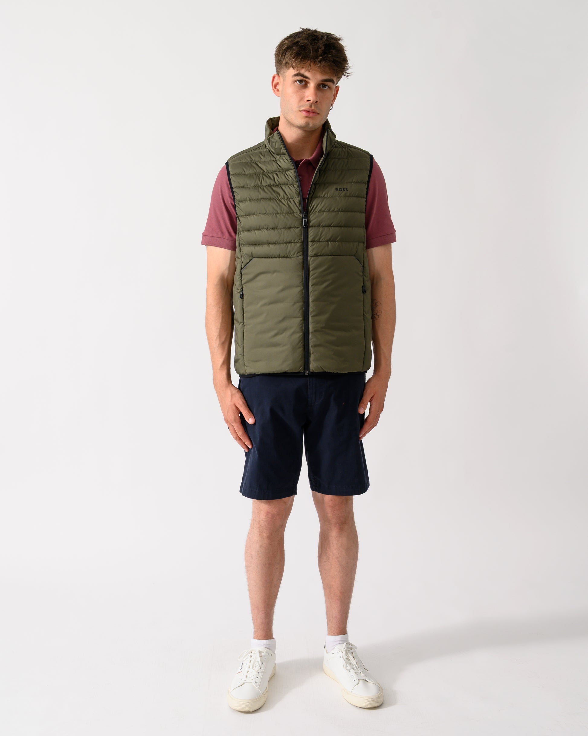 full length shot of a model wearing a BOSS Green Urbanex Mens Gilet in Open Green 398