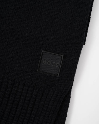 Close up of the logo of BOSS Orange Akaio R Mens plain-knit scarf with woven logo badge - Black 001