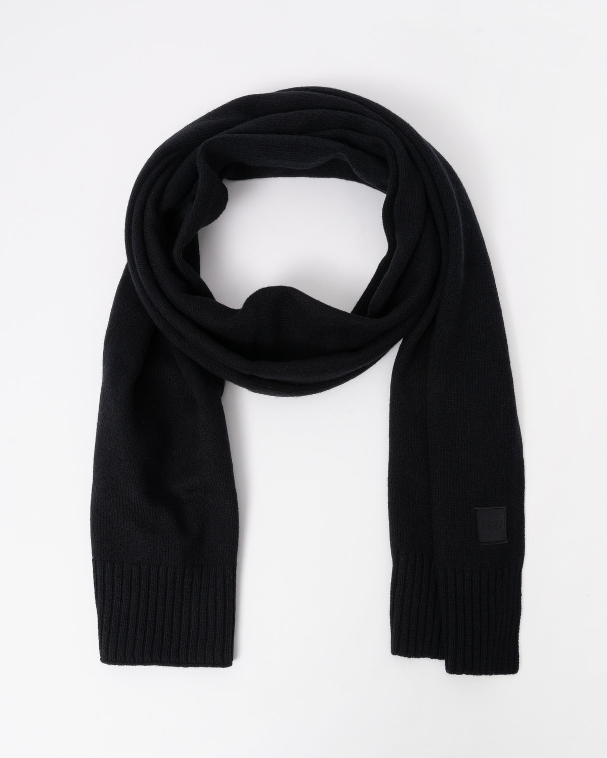 Flat lay of BOSS Orange Akaio R Mens plain-knit scarf with woven logo badge - Black 001